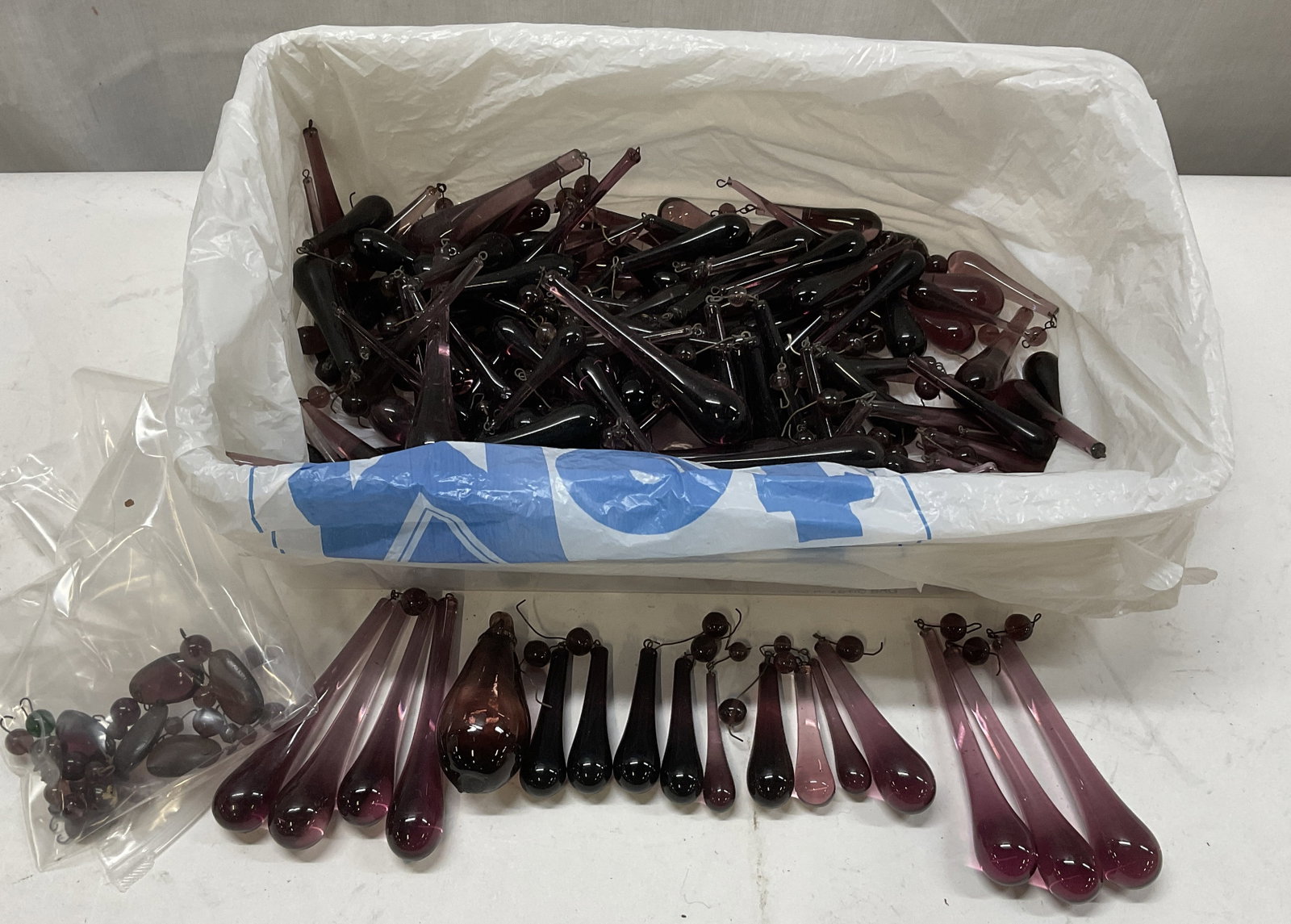 Group Lot 100+ Amethyst Glass Teardrops: Group Lot of 100+ Amethyst Glass Teardrops. Dark Purple and Light Purple. Various Sizes. Largest Measures app 4in H x 0.5in W. Some Chipping. Amethyst Glass, Purple Glass, Glass Teardrops, Chandelier 