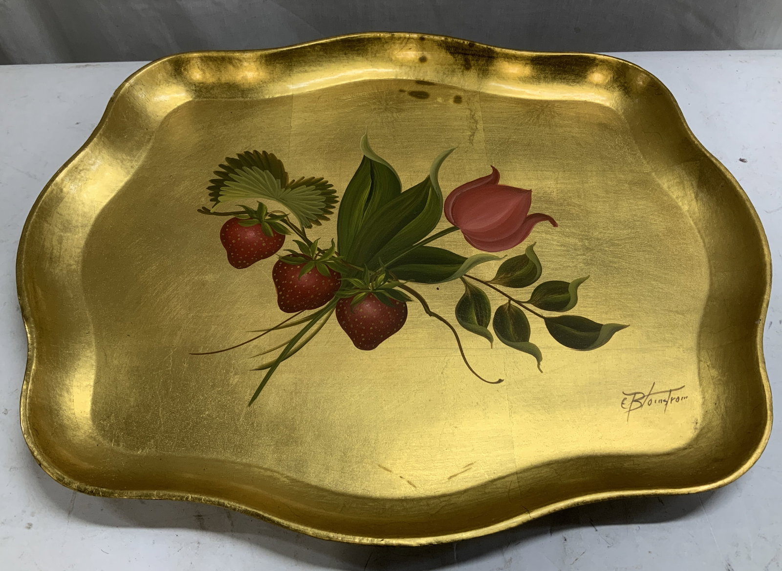 Sgnd Genuine Leaf Hand Decorated Serving Tray: Artist signed Serving tray features hand decorated leaf & strawberry motifs. Gilt finish & scalloped rim. Wooden material. Signed & marked on underside. Reads, GENUINE LEAF HAND DECORATED. Signed at