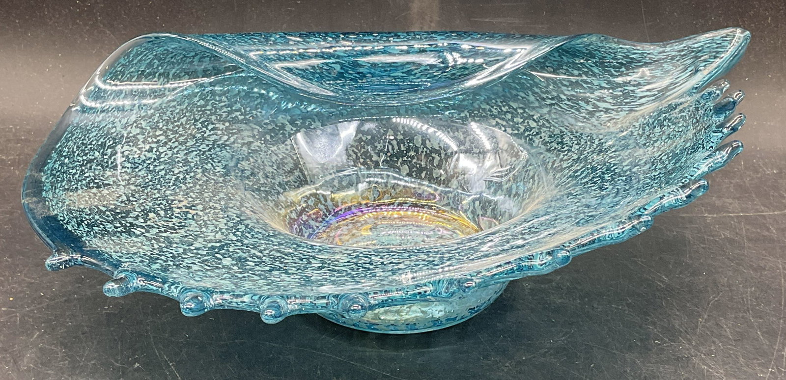 Hand Blown Blue Art Glass Seashell Bowl: Hand blown blue art glass seashell bowl with speckled design. Style of MURANO, no signature. Measures approx. 14 x 9 x 3.75 inches. Some scratching. Art glass bowl, seashell bowl, blue bowl, home deco