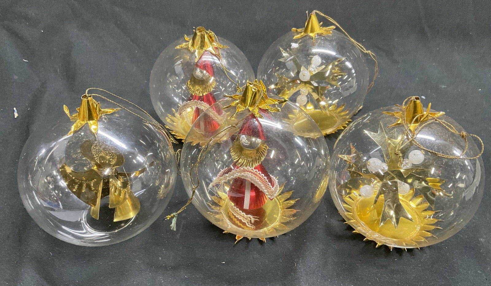 Lt5 VTG German Style Gold Foil Diorama Ornaments: 5 Vintage Gold Foil Diorama Spinner Glass Ball Ornaments. Resl Lenz West Germany Style. Includes 2 Santa Figures, 2 Snowflakes, and 1 Angel Figure. Some Bending. One Missing Base. Measures app 4in H. 