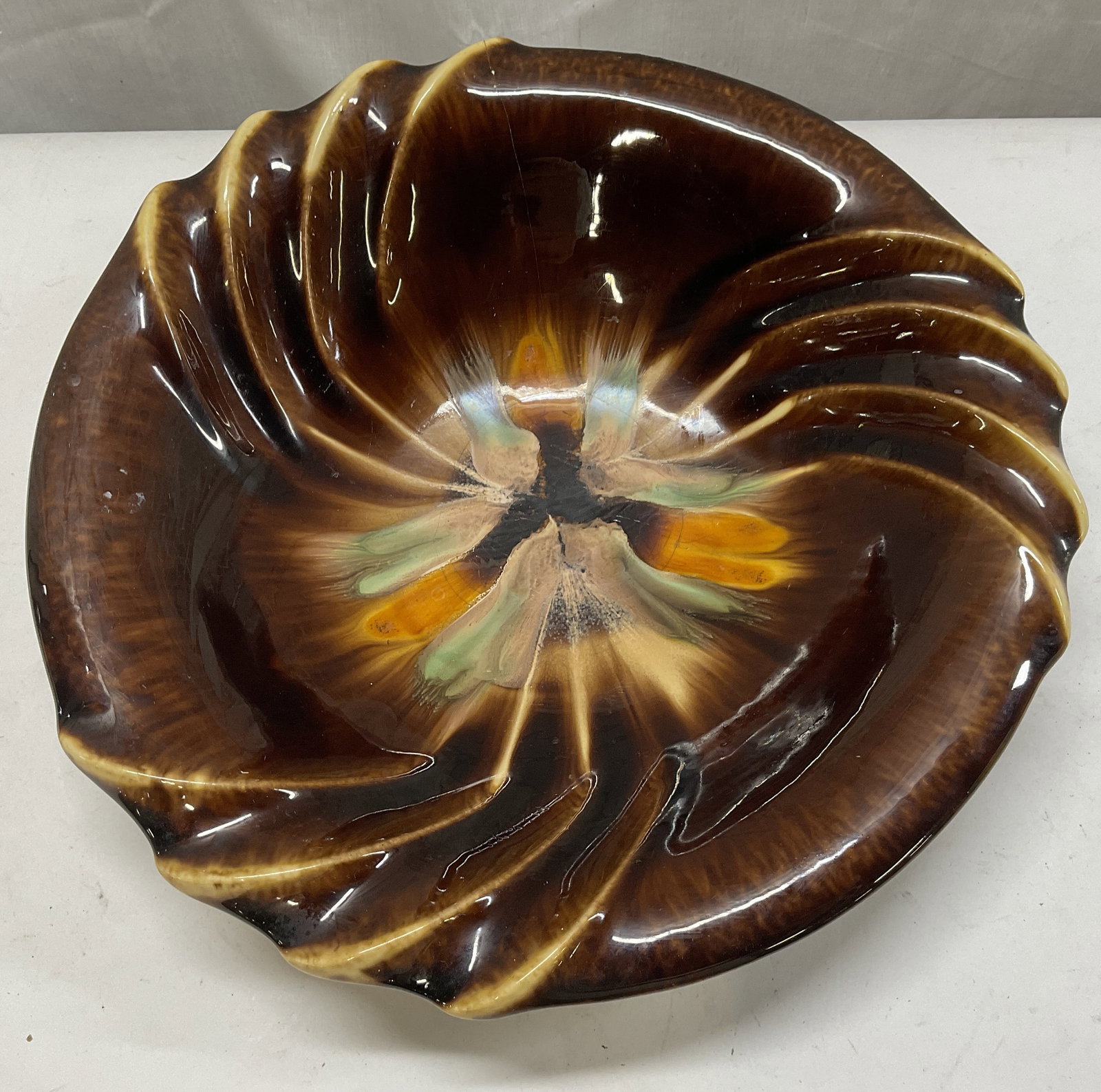Mid-Century Modern GERMAN Pottery Bowl: Mid-Century Modern German Pottery Bowl. Glossy Drip Glaze. Dark Brown with Tan Scalloped Design and Mint and Orange Swirls. Stamped #1087. Makers Mark Reads Illegibly. Cracks and Crazing Present. Meas