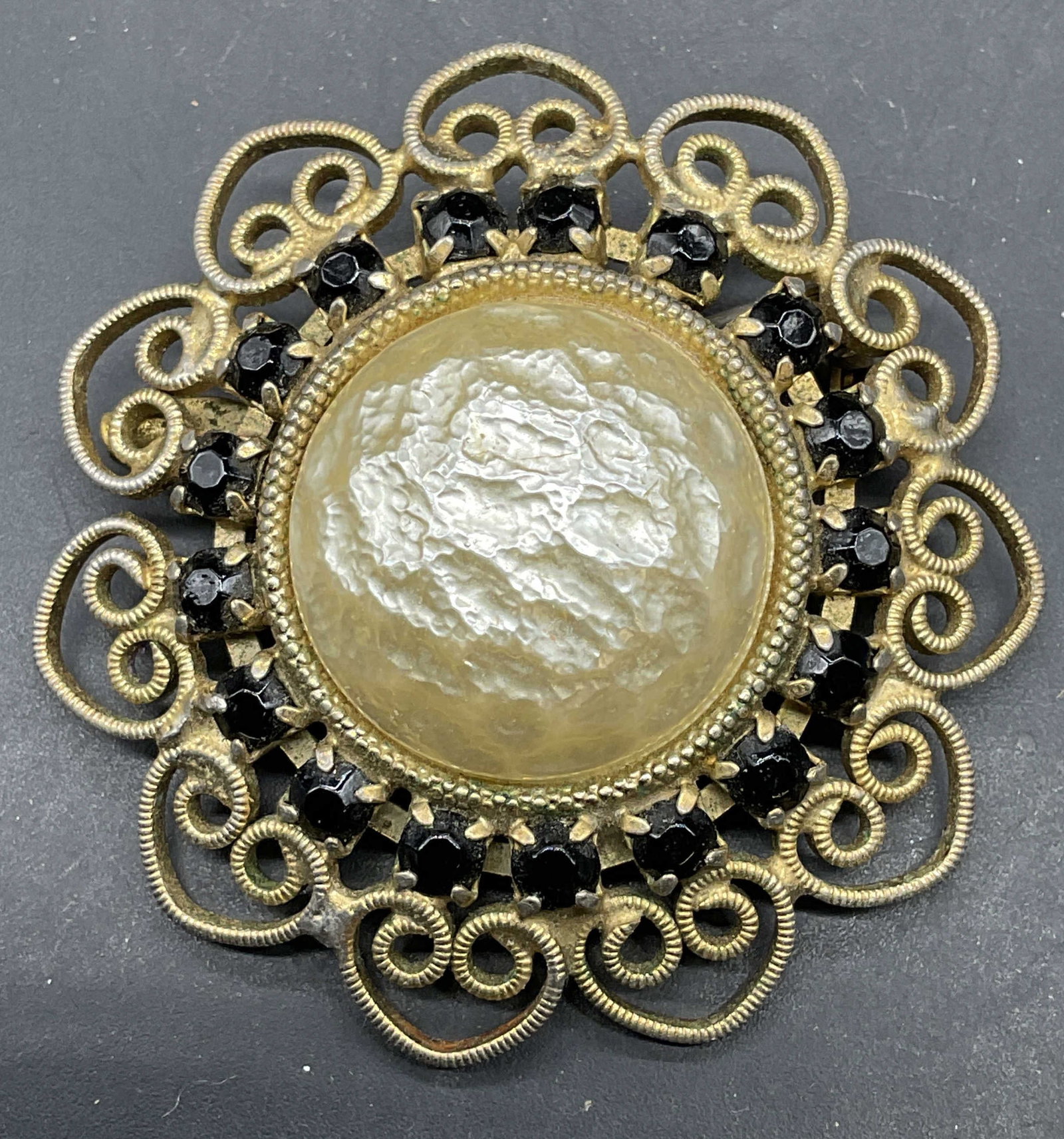Gold Tone Filigree Faux Pearl Crystal Brooch: Vintage Gold tone filigree brooch with black crystals and faux pearl. Measures approx. 2 inches wide. Some scratching. Jewelry, estate jewelry, costume jewelry, cocktail jewelry, fashion jewelry, acce