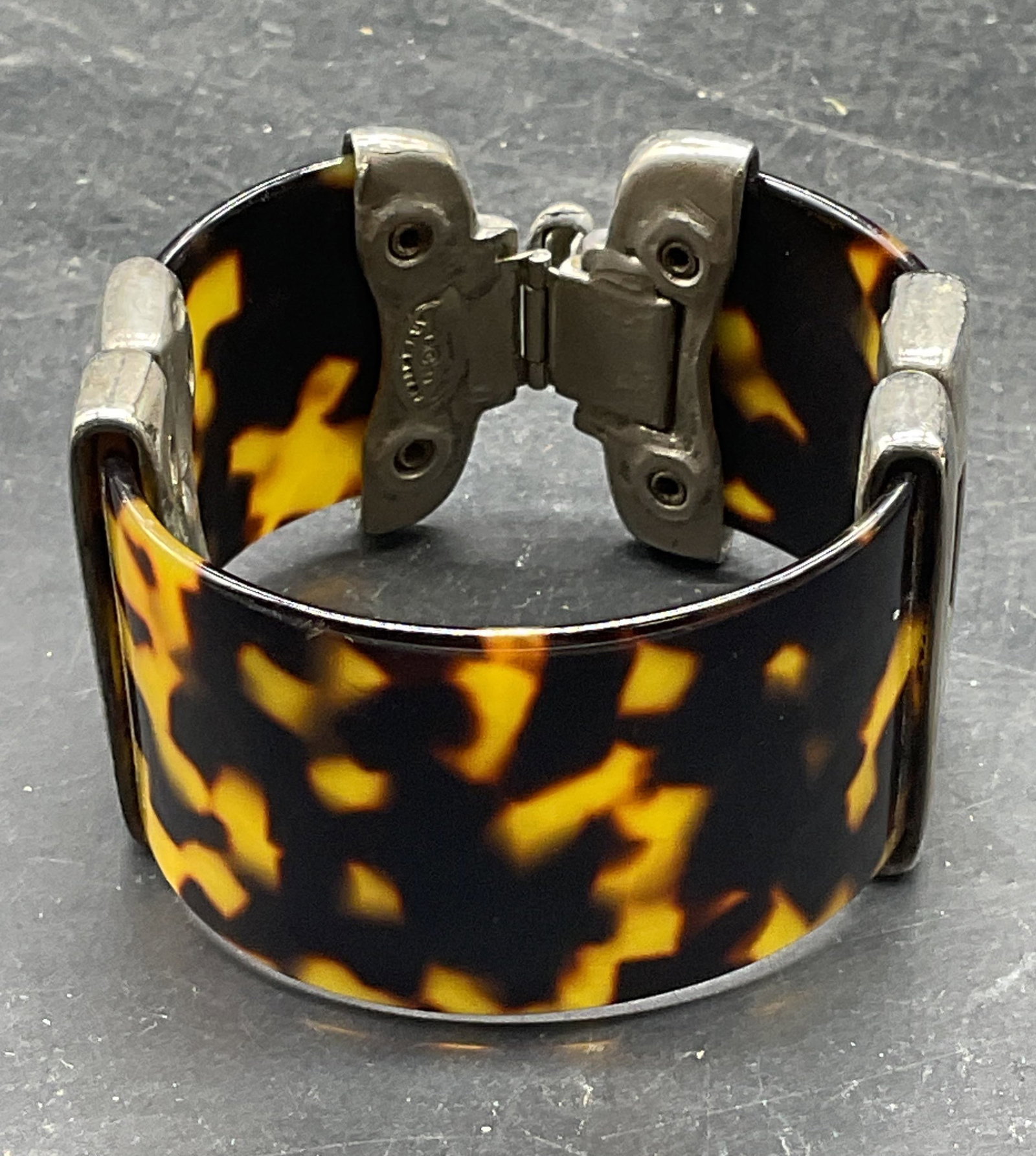 Clara Studio Asymmetry Faux Tortoise Bracelet: Vintage 1994 Clara Studio for Asymmetry silver tone faux tortoise lucite bracelet. Measures approx. 2.25 inches wide. Some scratching. Jewelry, estate jewelry, costume jewelry, cocktail jewelry, fashi