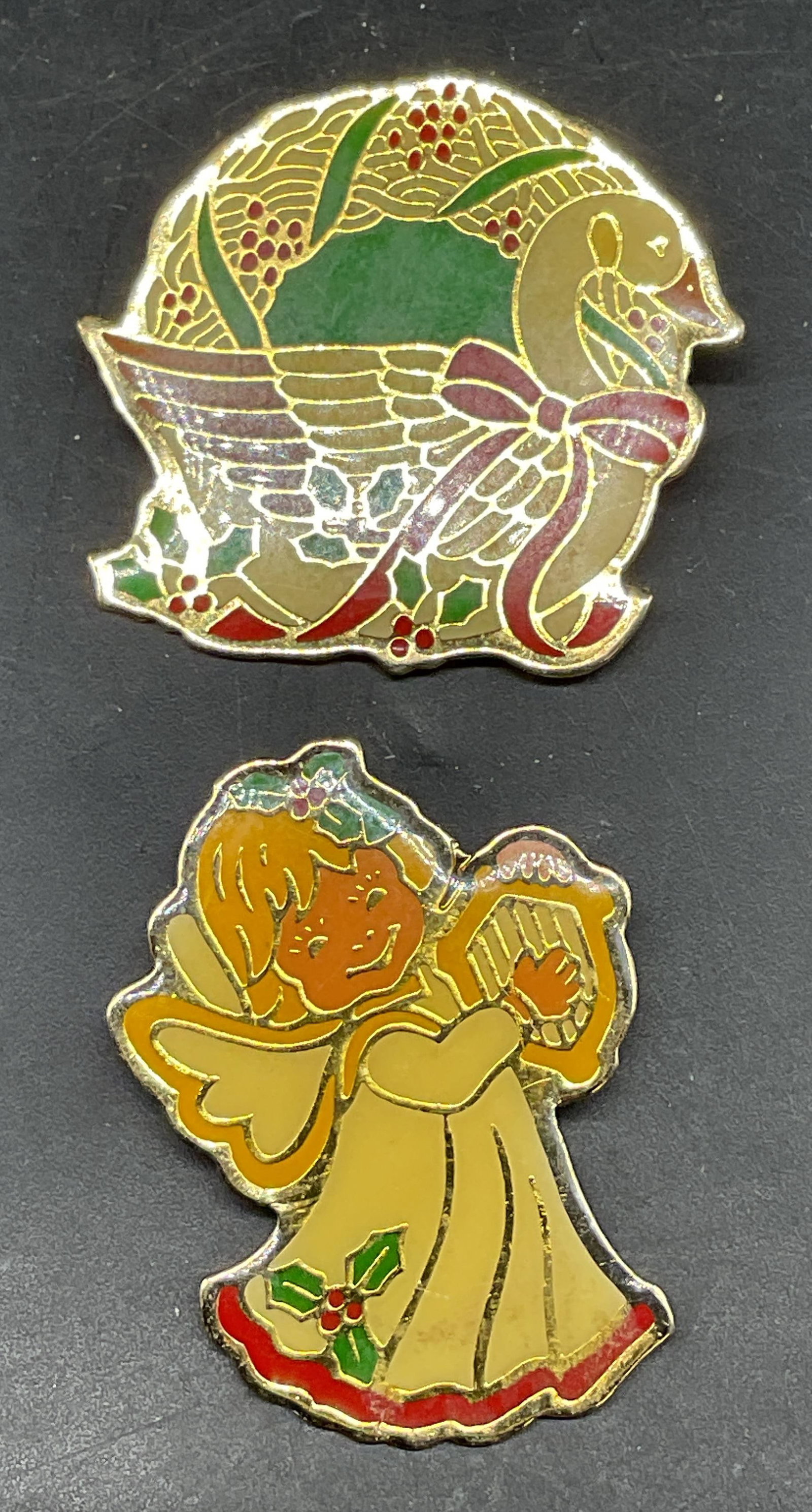Lot 2 Angel & Goose Christmas Brooches: Lot of 2 gold tone enameled Christmas themed brooches. Angel and goose motifs. Larger measures approx. 1.5 x 1 inches. Some scratching. Jewelry, estate jewelry, costume jewelry, cocktail jewelry, fash