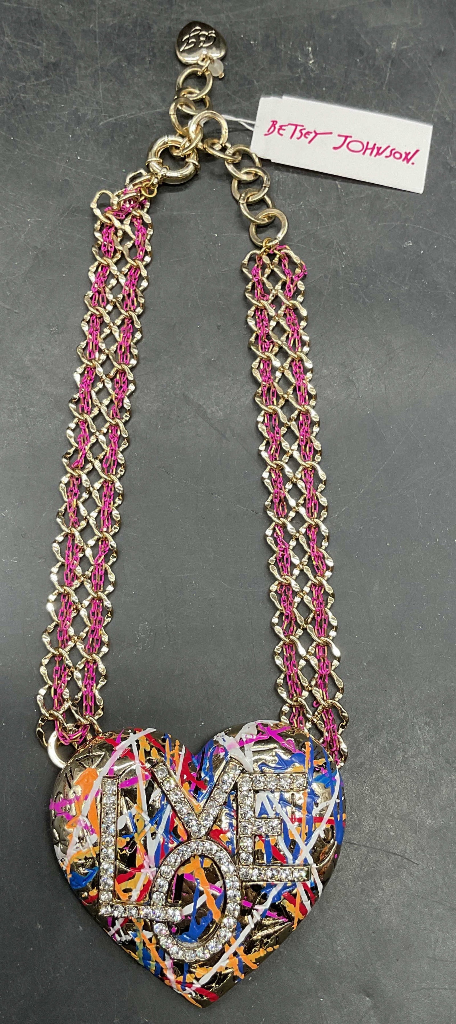 Betsy Johnson Love Statement Necklace NWT: Betsy Johnson statement necklace. Woven gold tone and pink chain with graffiti heart Love motif crystal and enamel pendant. New with tag. Drop length 7 inches. Pendant measures approx. 2.75 x 2.5