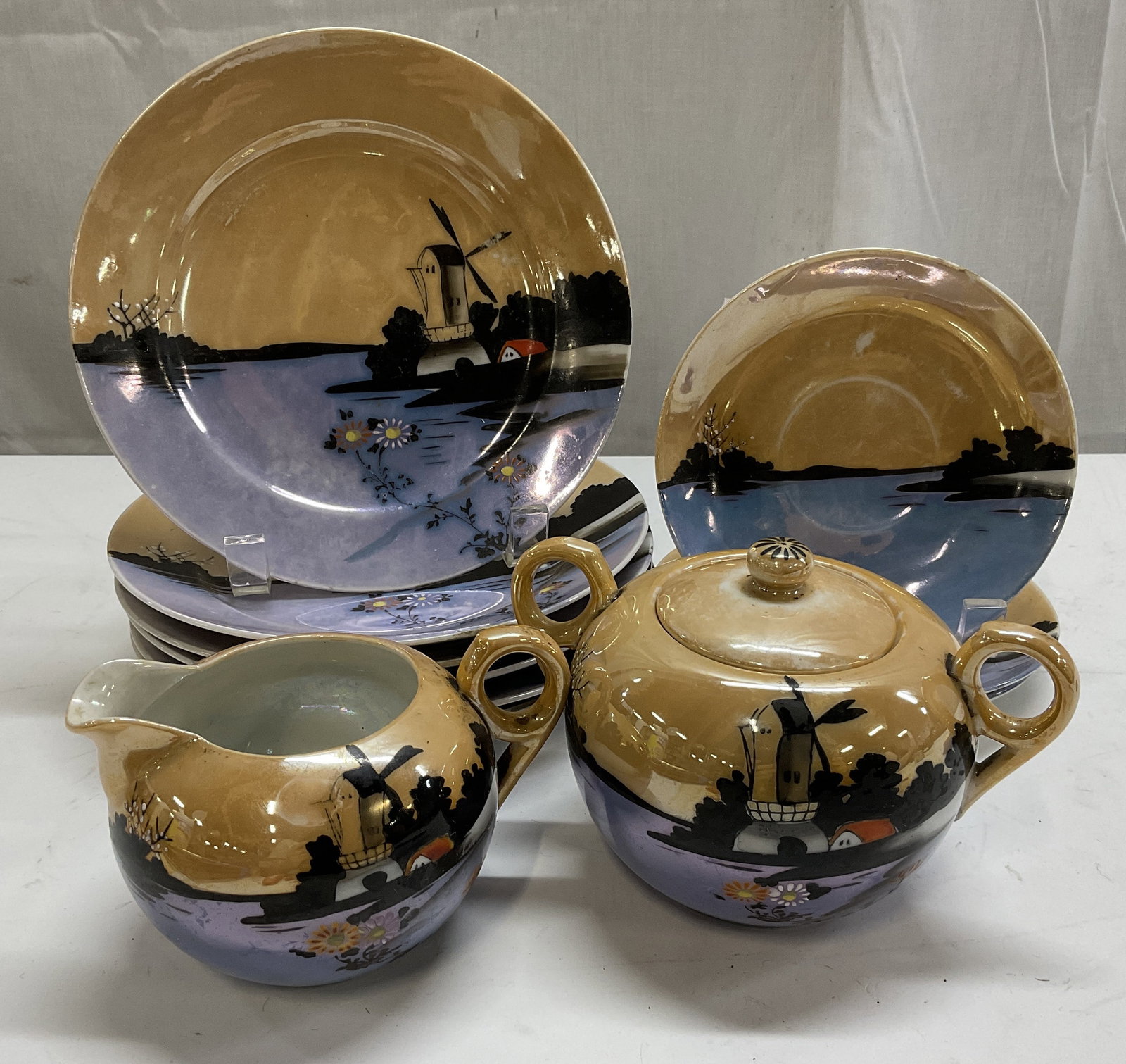 St 10 VTG Windmill Landscape Japanese Lusterware: Set of 10 Vintage Japanese Lusterware. Porcelain with Hand-Painted Iridescent Peach and Periwinkle Landscape Scenes of a Windmill, Water, and Trees. Includes 6 Lunch Plates, 3 Dessert Plates, A Lidded