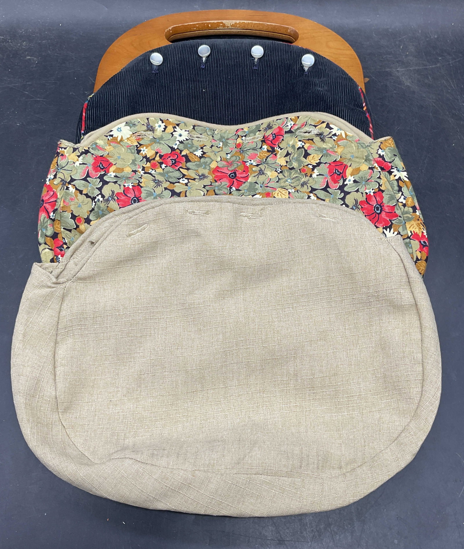 Vintage Wood Handle Handbag with Covers: Vintage wood handle handbag with three interchangeable covers. Black corduroy, tan woven cotton, and green floral print. Mother of pearl buttons. Handbag measures approx. 10 x 9 inches. Some scratchin