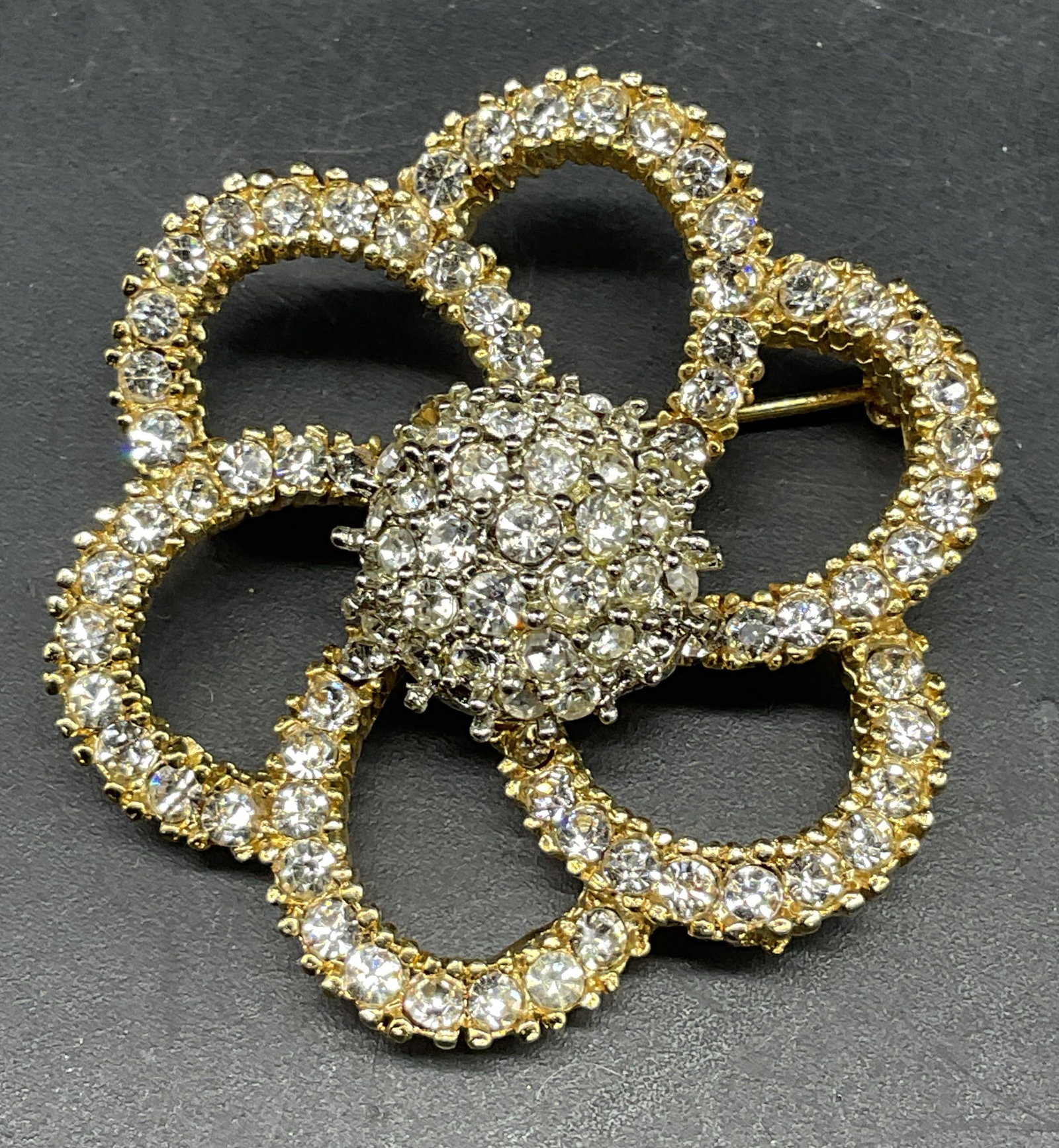 Vintage Todd Anthony Gold Tn Crystal Flower Brooch: Vintage signed Todd Anthony gold tone flower brooch with colorless crystals. Measures approx. 1.5 inches wide. Some scratching. Jewelry, estate jewelry, costume jewelry, cocktail jewelry, fashion
