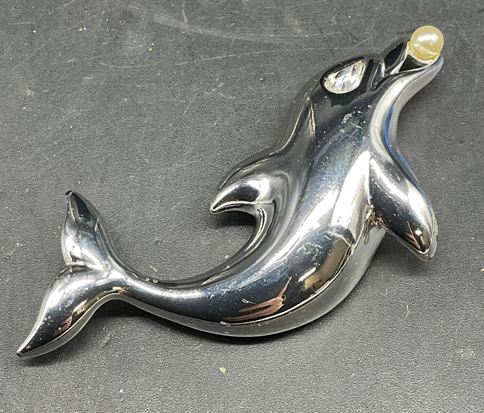 Vintage Napier Faux Pearl Dolphin Brooch: Vintage signed Napier silver tone faux pearl and crystal dolphin brooch. Measures approx. 1 x 2.75 inches. Some scratching. Jewelry, estate jewelry, costume jewelry, cocktail jewelry, fashion jewelry,