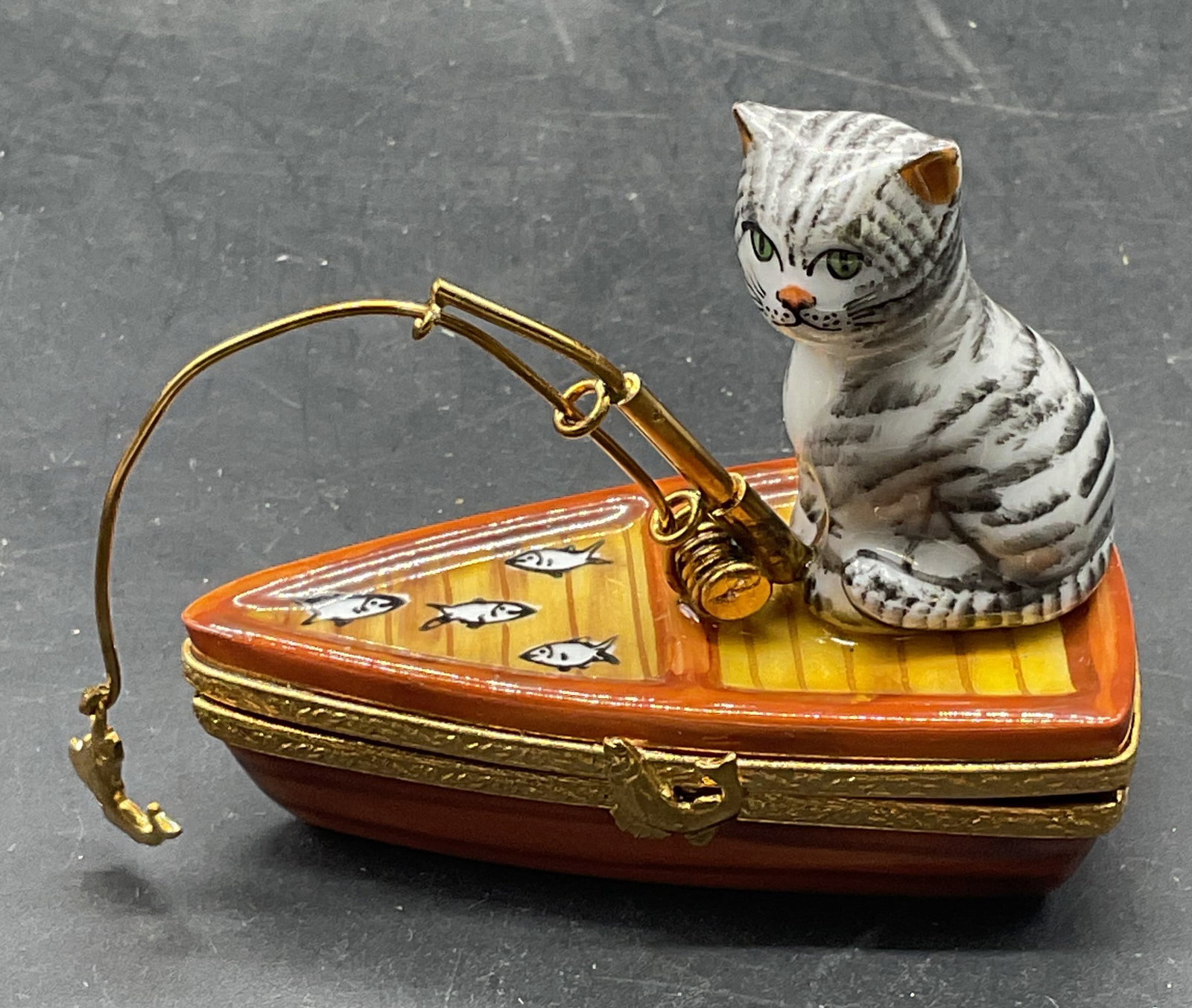 PPA Limoges Porc Cat Fishing Trnkt Box Ltd Ed Frnc: PPA Limoges porcelain limited edition cat and boat fishing trinket box. Made in France. Numbered 74/500. Hand painted. Measures approx. 2.5 x 1.5 x 2 inches. Some scratching. Limoges trinket box, cat 