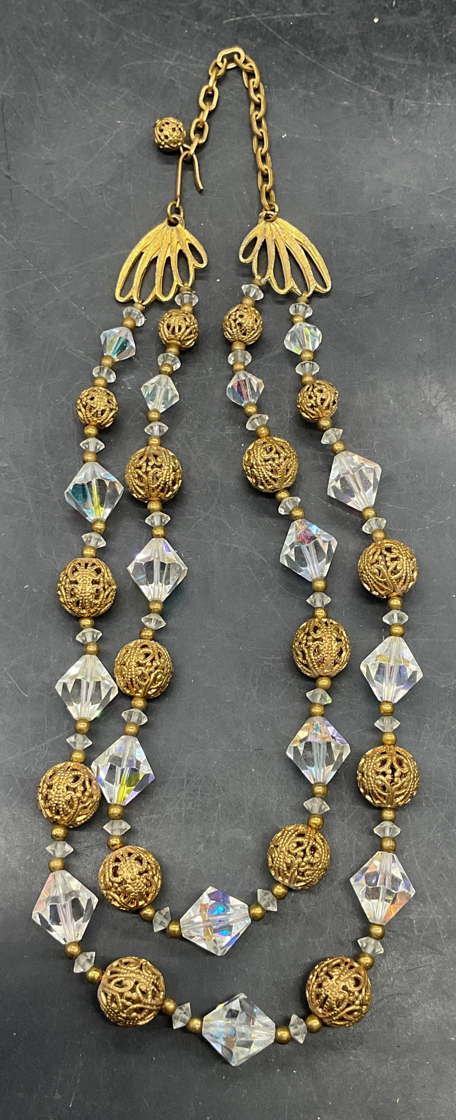 Vintage Gold Tone Crystal Beaded Necklace: Vintage gold tone and crystal beaded double strand necklace. Drop length 7.5 inches. Some scratching. Jewelry, estate jewelry, costume jewelry, cocktail jewelry, fashion jewelry, accessories, fashion