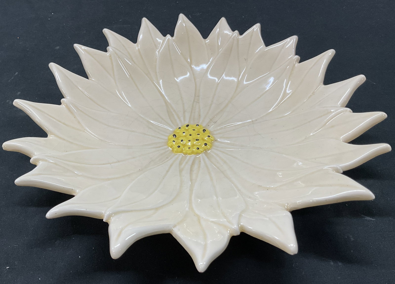 Atlantic Ceramic Poinsettia Flower Dish: Atlantic ceramic poinsettia flower dish. Marked and signed on underside. Hand painted poinsettia flower in varying colors. Scalloped edge. Textured surface. Glossy finish. Measures approx 10 inches