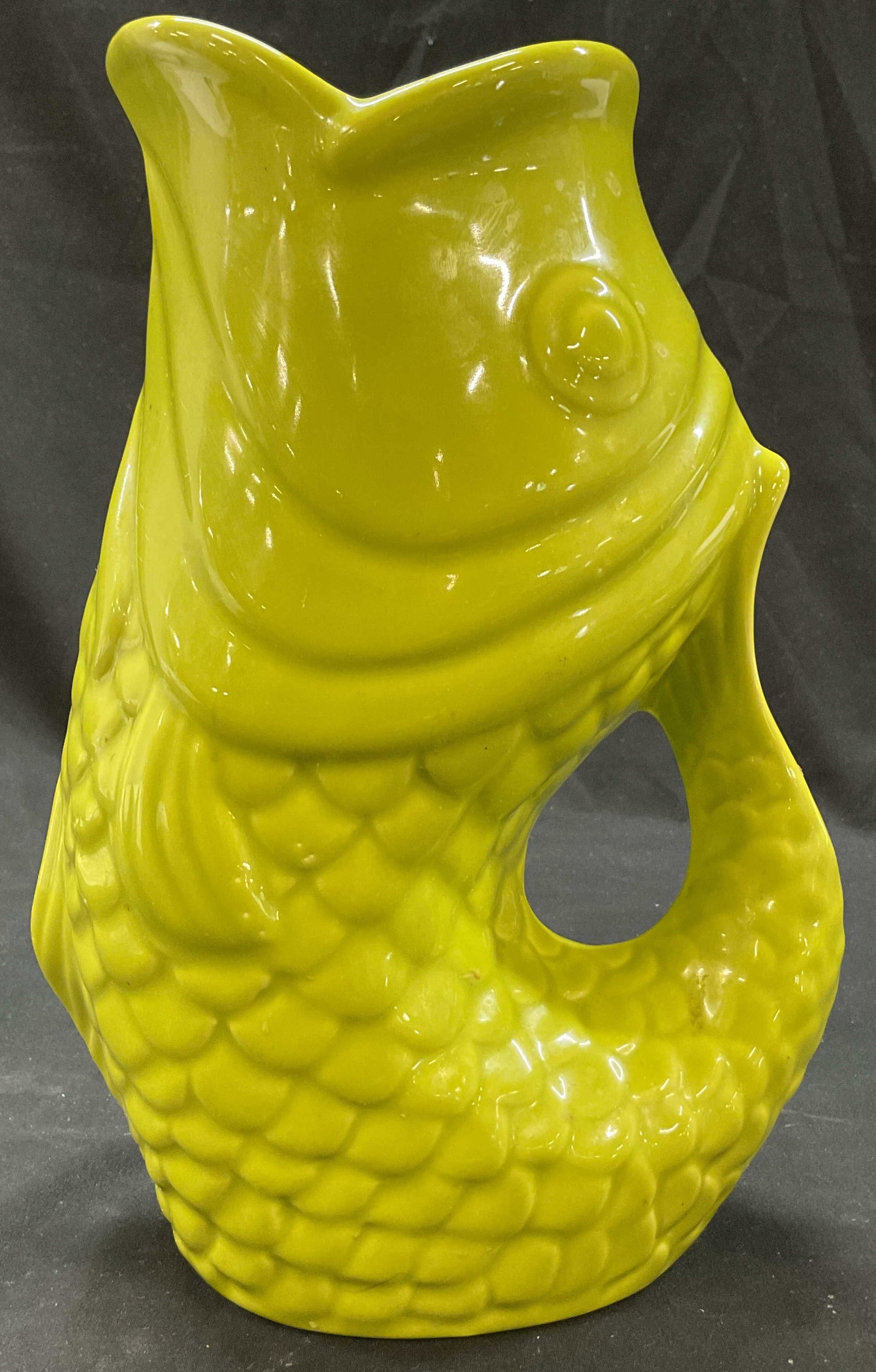 Bistro Brights Green Ceramic Guggle Fish Pitcher: Bistro Brights green ceramic guggle fish pitcher. Marked Bistro Brights on underside. Fish figure. Green glaze and glossy finish. Ribbed surface. Detailed features and textures. Handle and wide spout.