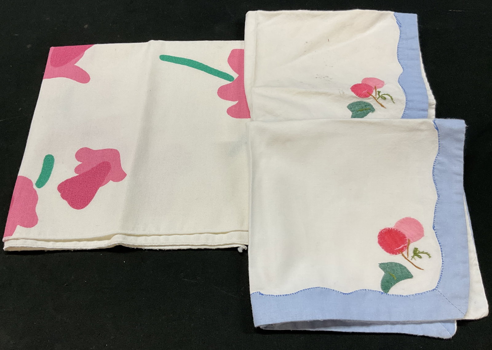 Lot 3 Vintage Floral & Cherry Linen Napkins: Lot of 3 vintage white embroidered floral and cherry linen napkins. Floral pattern in pink and green. Embroidered cherry motif in pink, red, and green. Blue border. Largest measures approx 16 x 16