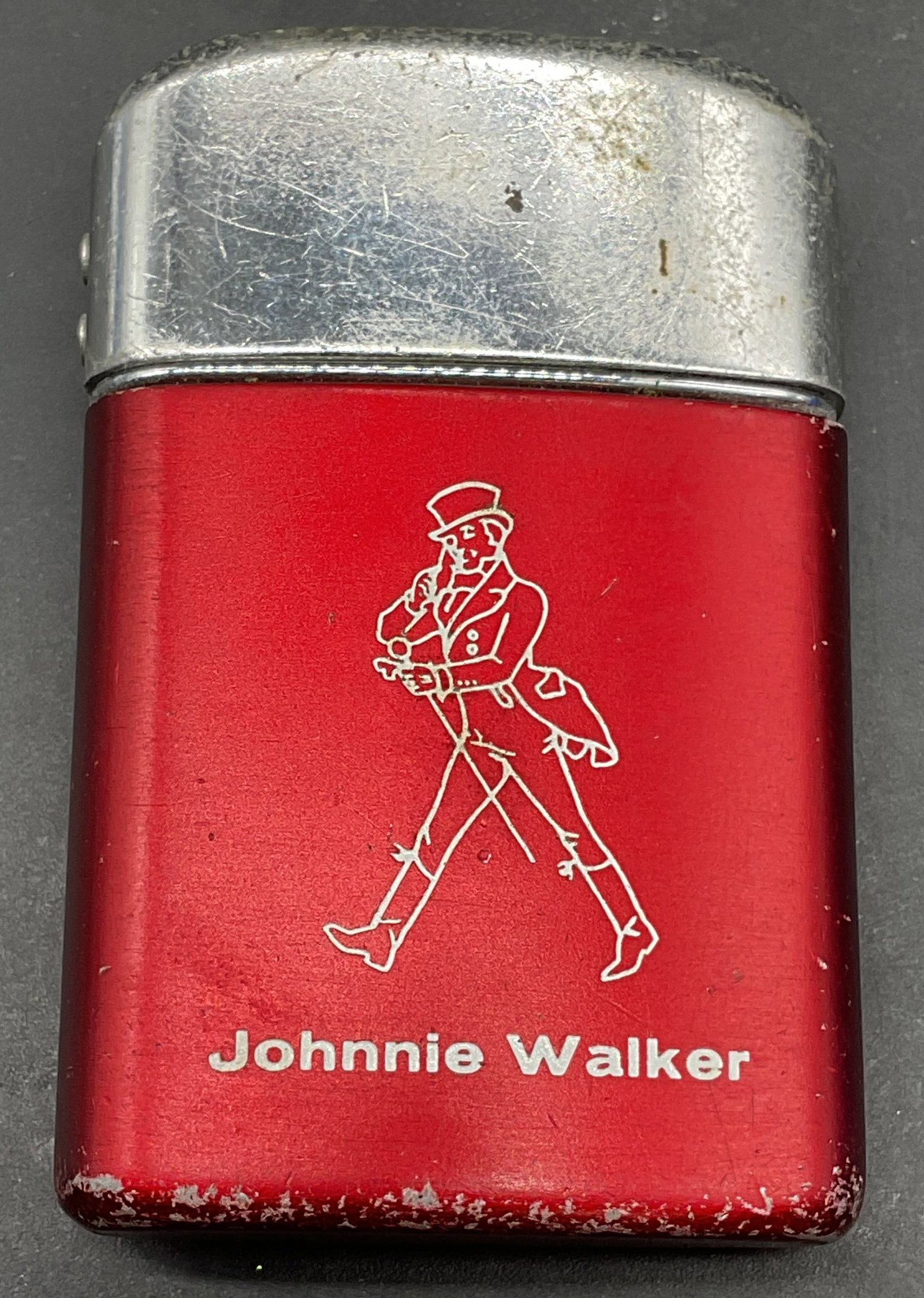 RONSON Johnnie Walker Advertising Lighter: RONSON Typhoon Johnnie Walker advertising lighter in red and silver tone. Measures approx. 2.25 x 1.5 x .5 inches. Some scratching. Not tested. Vintage lighter, pocket lighter, collectibles, home