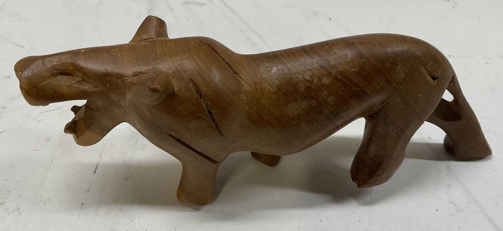 MCM Hand-Carved Wooden Lion Figurine: Mid-Century Modern Hand-Carved Wooden Lion Figurine. Condition Consistent with Exposure. Measures app 2in H x 6.25in L. Vintage Animal Figurine, Mid-Century Modern, MCM, Hand-Carved, Wooden Lion,