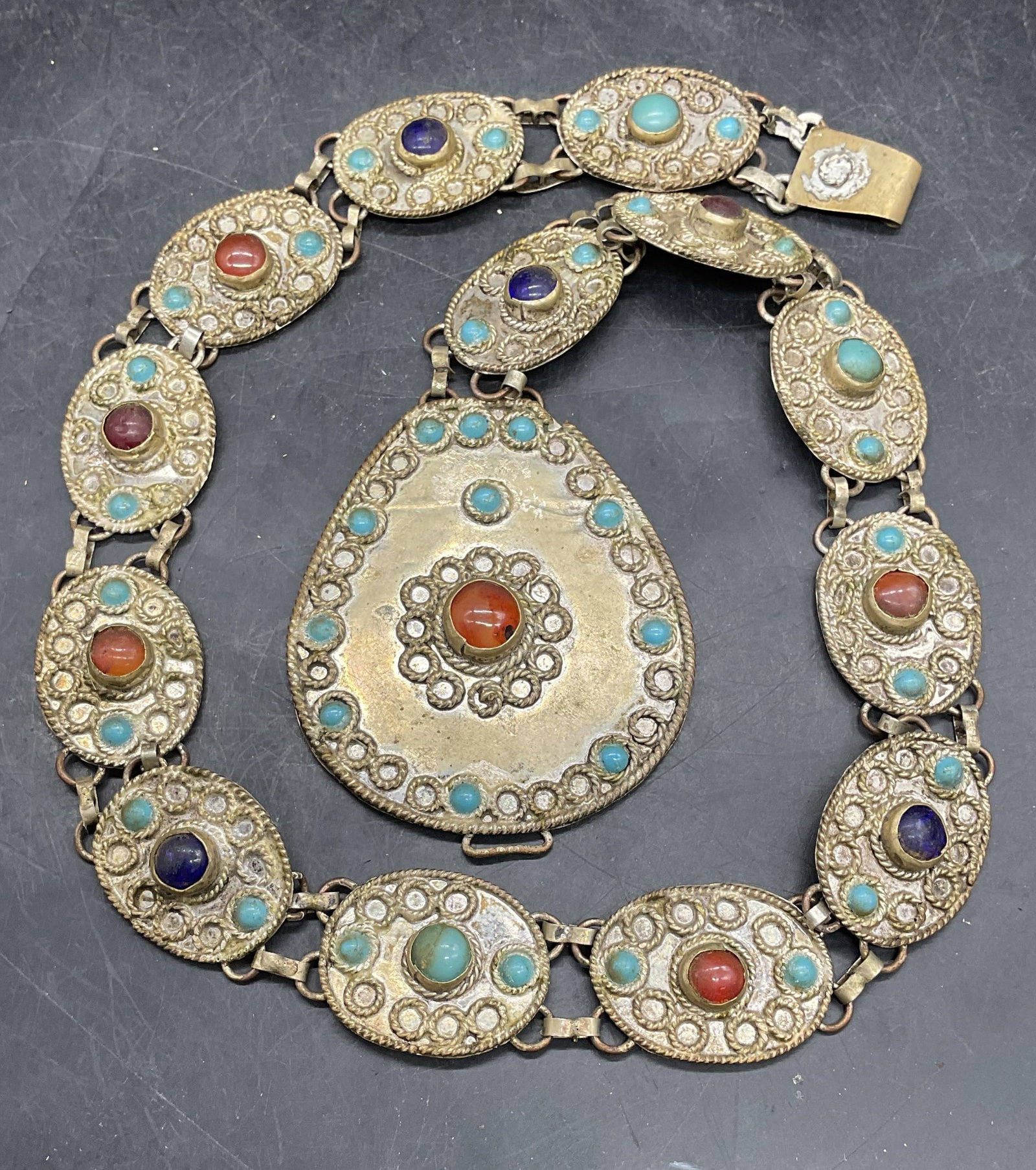 Vtg Silver Tone Bejeweled Turquoise Panel Belt: Vintage handcrafted silver tone panel belt with bejeweled turquoise and colored stones. Measures approx. 28 inches long. Wear including scratching and patina. Some losses and previous repairs.
