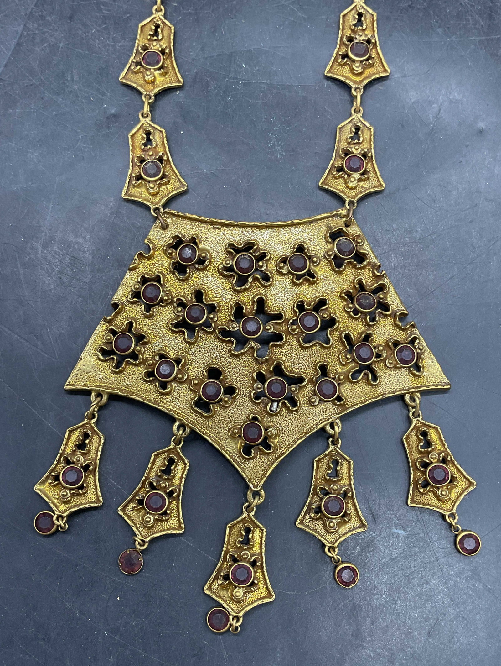 Goldette Gold Tone Crystal Statement Necklace: Vintage Goldette gold tone statement pendant necklace with purple crystals. Drop length 8.5 inches. Some scratching. Jewelry, estate jewelry, costume jewelry, cocktail jewelry, fashion jewelry,