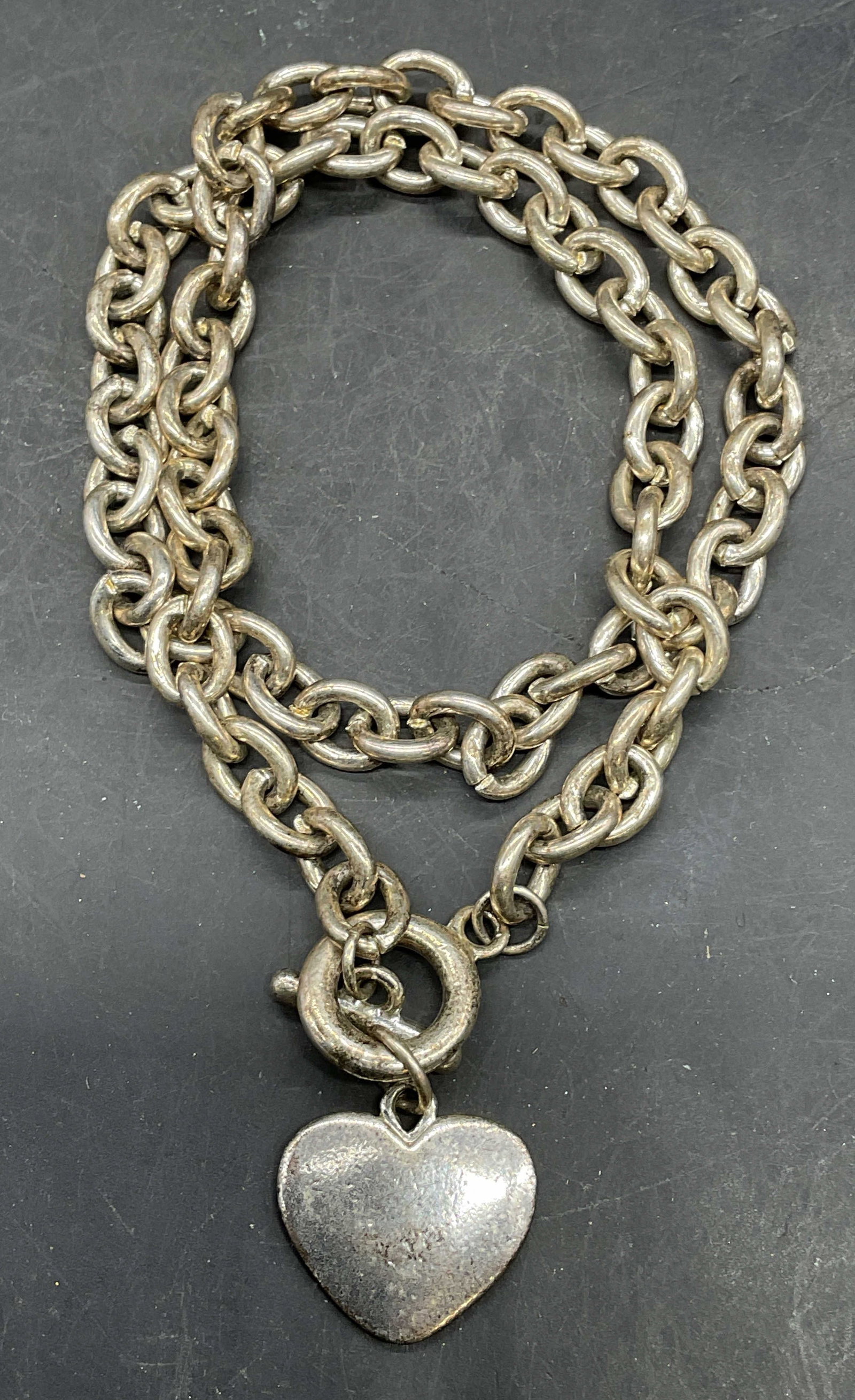 Vintage Silver Tone Heart Pendant Necklace: Vintage silver tone chain necklace with toggle clasp and heart pendant. Drop length 8.5 inches. Some scratching. Jewelry, estate jewelry, costume jewelry, cocktail jewelry, fashion jewelry,