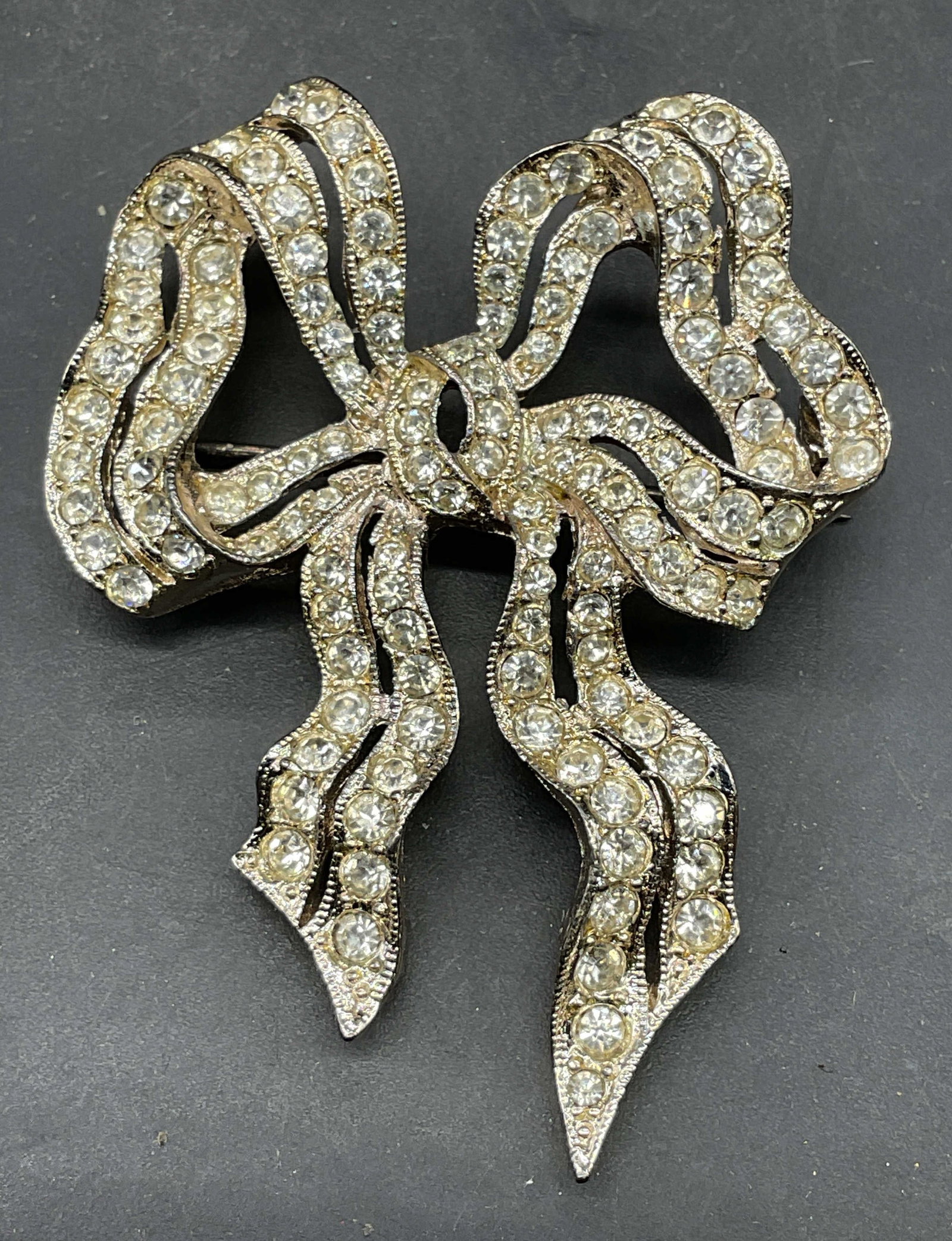Vintage Carolee Silver Tone Crystal Bow Brooch: Vintage Carolee silver tone crystal bow ribbon brooch. Measures approx. 2 x 1.5 inches. Some scratching. Jewelry, estate jewelry, costume jewelry, cocktail jewelry, fashion jewelry, accessories, fashi