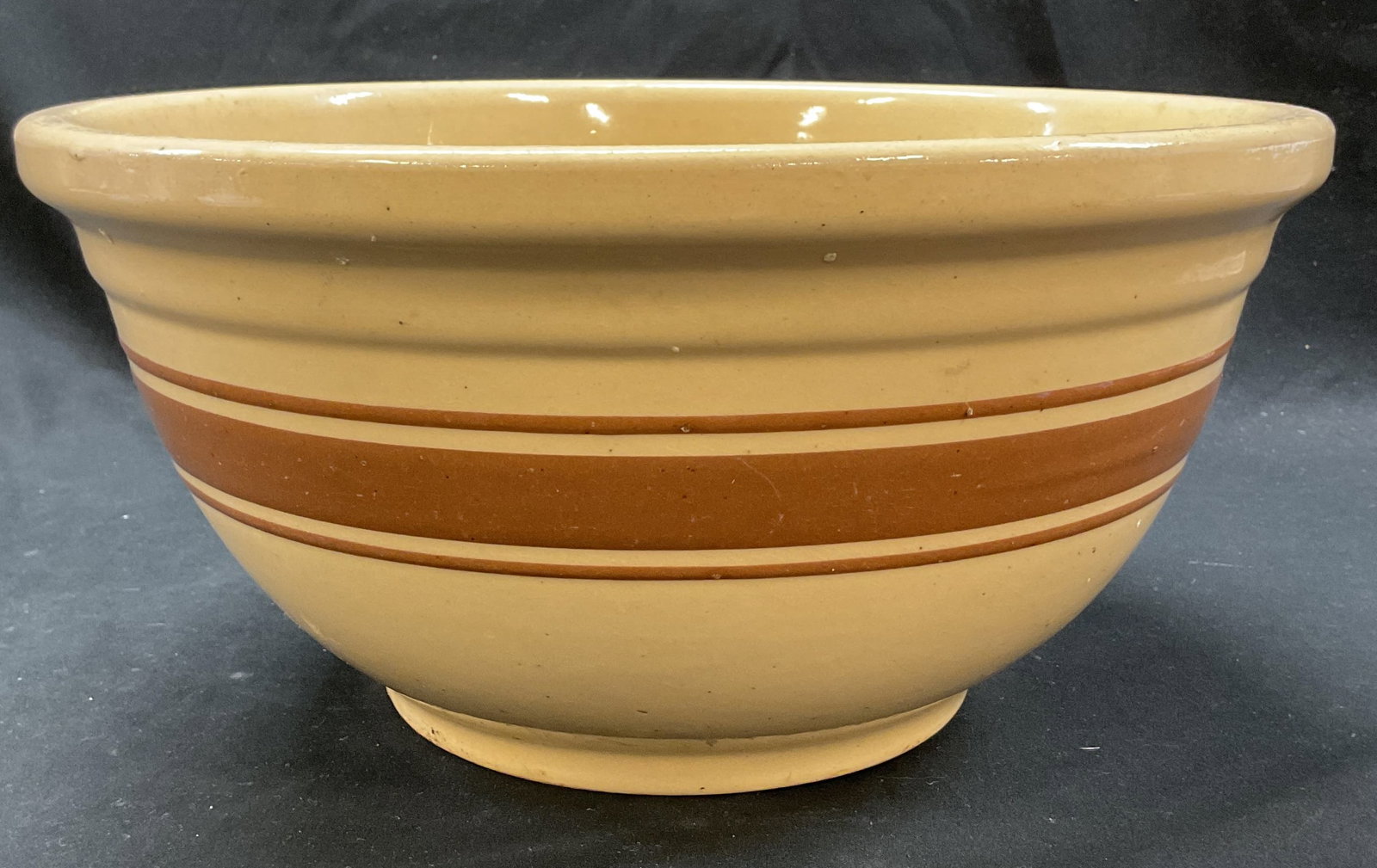 Watt Ovenware Decorative Bowl USA: Watt Ovenware stoneware decorative bowl. Marked on underside, reads Ovenware Watt USA. Large round bowl. Cream color with brown stripes. Measures ht approx 6 inches diam approx 12 inches. Some