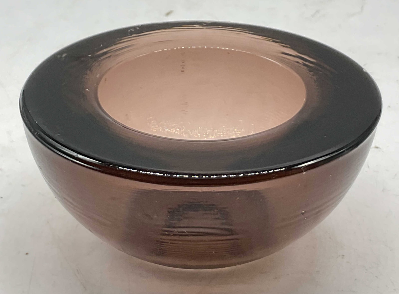 Hand Blown Purple Art Glass Votive Holder: Hand blown purple art glass votive holder. Round shape and thick walled. Purple tint. Measures ht approx 2 inches diam approx 4 inches. Some scratching. Votive holder, bowl, candle holder, art glass,