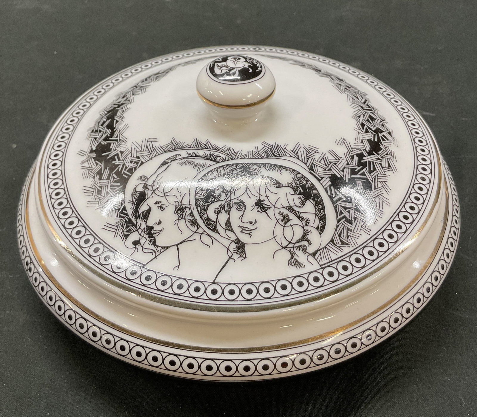 Hollohaza Porcelain Lidded Trinket Box Hungary: Hollohaza porcelain lidded bonbonniere trinket box. Marked on underside, reads Hollohaza Hungary. Round box with black and white geometric pattern and gilt trim. Decorative gilt handle on lid with