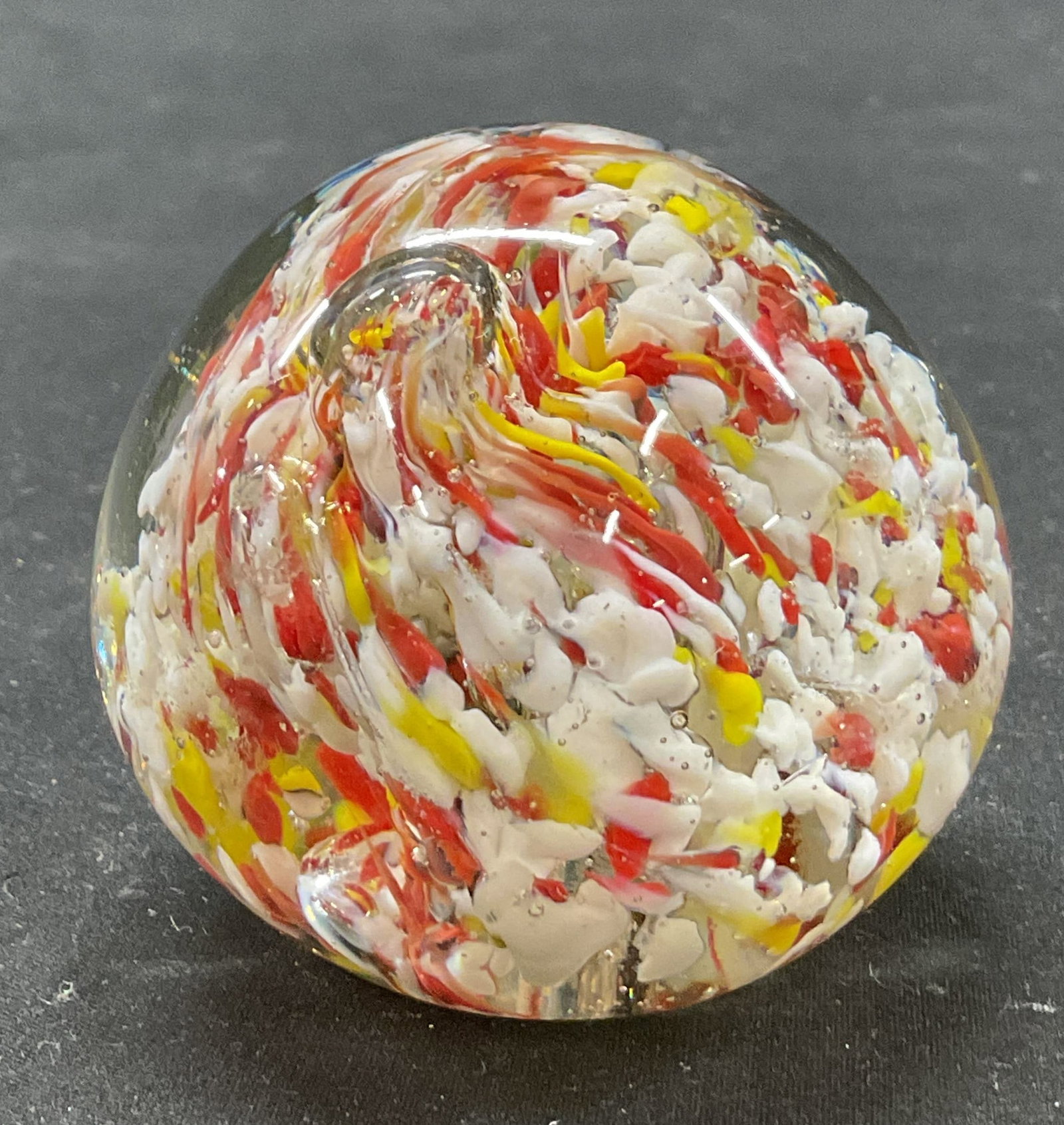 Hand Blown Swirled Art Glass Paperweight: Hand blown swirled art glass paperweight. Spherical shape. Swirled design in white, red, and yellow. Measures ht approx 2.5 inches diam approx 2 inches. Some scratching. Paperweight, home decor,