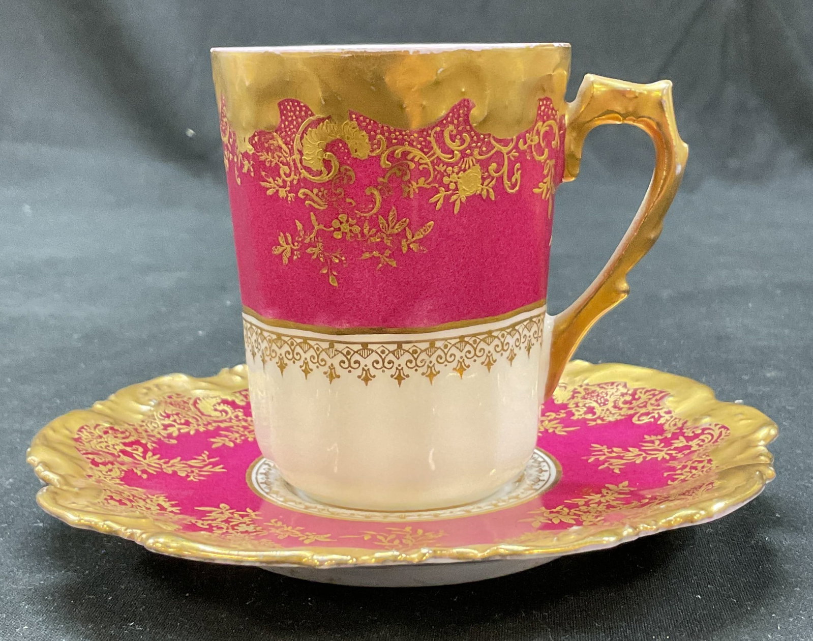 Set 2 Limoges Porcelain Teacup & Saucer France: Set of 2 Lewis Strauss & Sons Limoges porcelain teacup and saucer. Marked on underside, reads LS & S Limoges France. Scalloped edge. Gilt and red floral and scroll motifs. Saucer measures approx 5
