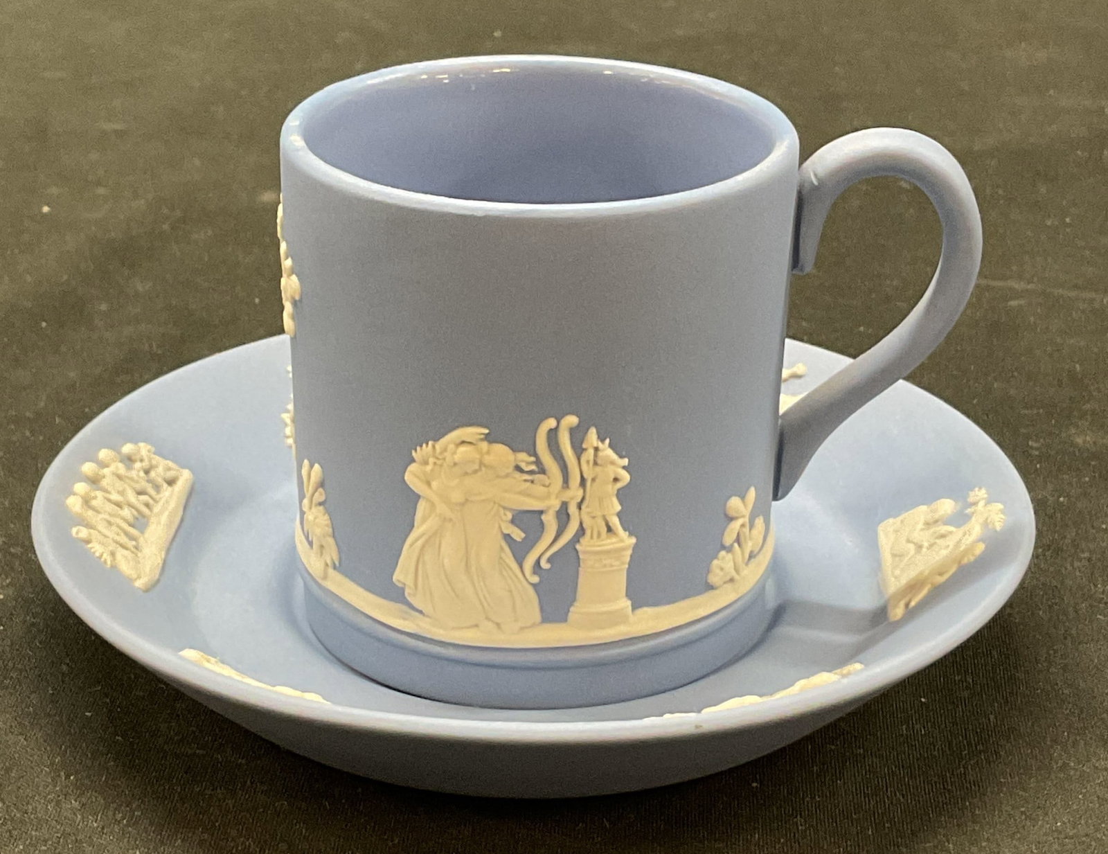 Set 2 Wedgwood Jasperware Teacup & Saucer England: Set of 2 Wedgwood blue Jasperware teacup and saucer. Marked on underside, reads Wedgwood Made In England. White bas relief neoclassical decorations. Figural and tree motifs. Saucer measures approx
