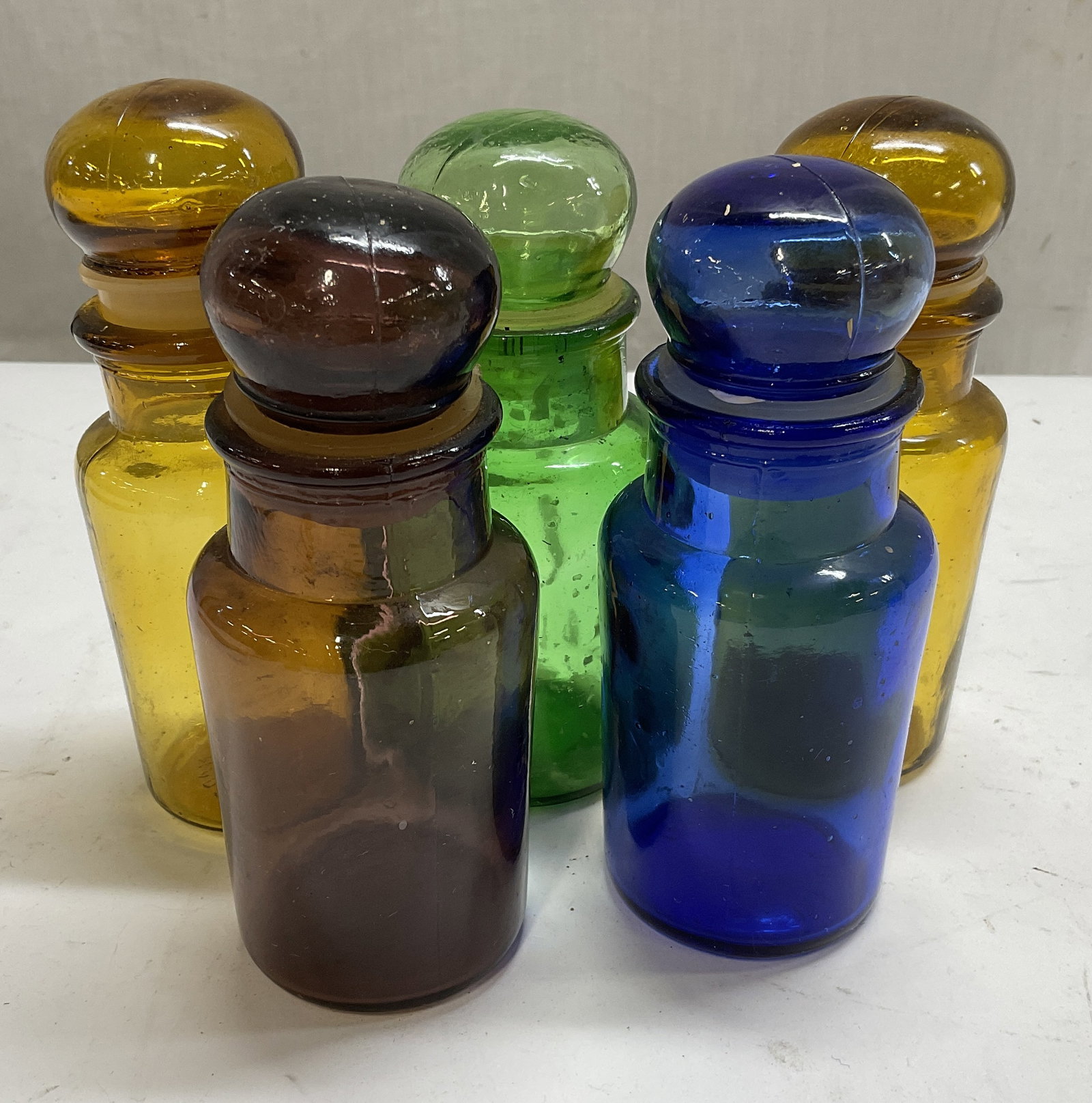 Lt 5 VTG Colorful Glass Bubble Lid Apothecary Jars: 5 Vintage Colorful Glass Bubble Lid Apothecary Jars. 2 Amber, 1 Green, 1 Purple, 1 Cobalt Blue. Chips and Residue Present. Measures app 5in H x 2in Diam. Vintage Jars, Colorful Glass, Bubble Lid, Apot