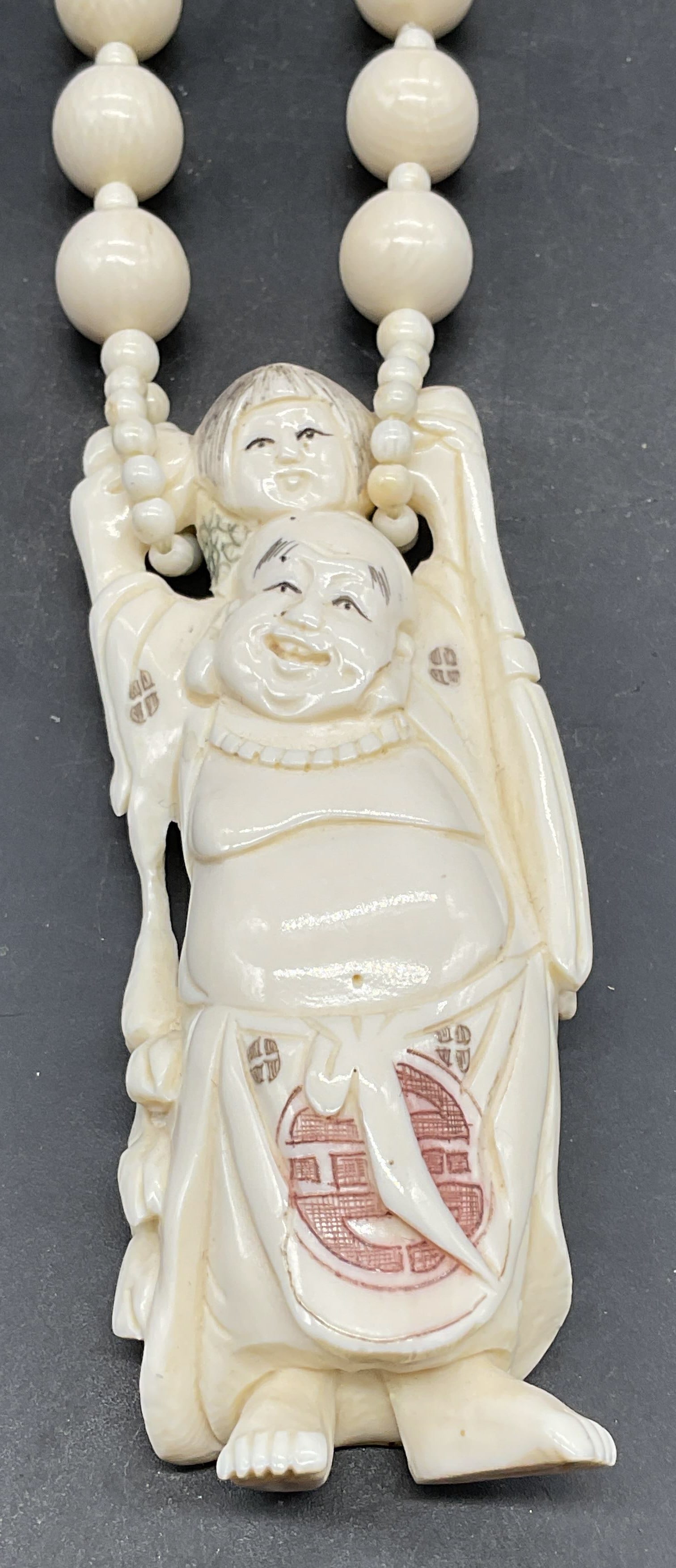 Vintage Faux Bone Laughing Buddha Necklace: Vintage faux bone beaded necklace with caved laughing Buddha pendant. Drop length 15 inches. Some scratching. Jewelry, estate jewelry, costume jewelry, cocktail jewelry, fashion jewelry, accessories,
