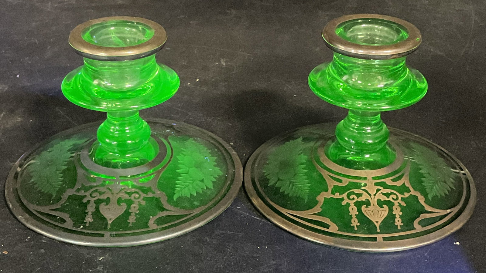 Uranium Depression Glass Silver Candle Holders: Vintage Uranium green depression glass candle holder with sterling silver overlay. Etched floral motif with ornate silver scroll. Measures approx. 4.5 x 3.25 inches. Glass is UV light reactive. Some s