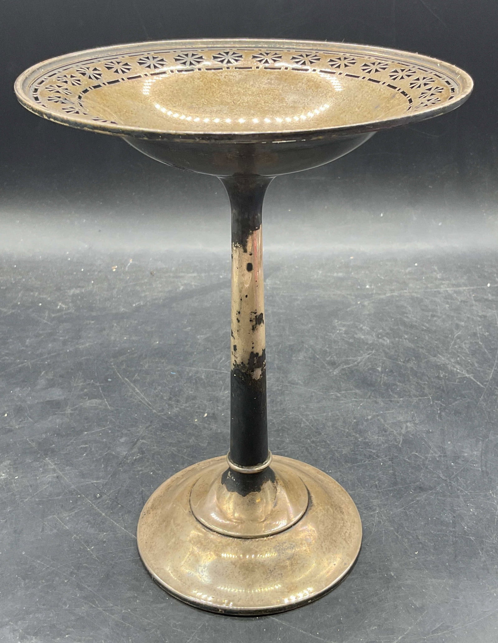 Vintage Sterling Silver Footed Tazza: Vintage sterling silver tazza. Round footed base with tapered column and reticulated floral rim. Marked sterling. Numbered G 190-1. Measures approx. 6 x 8 inches. Total weight 174.6 grams. Wear