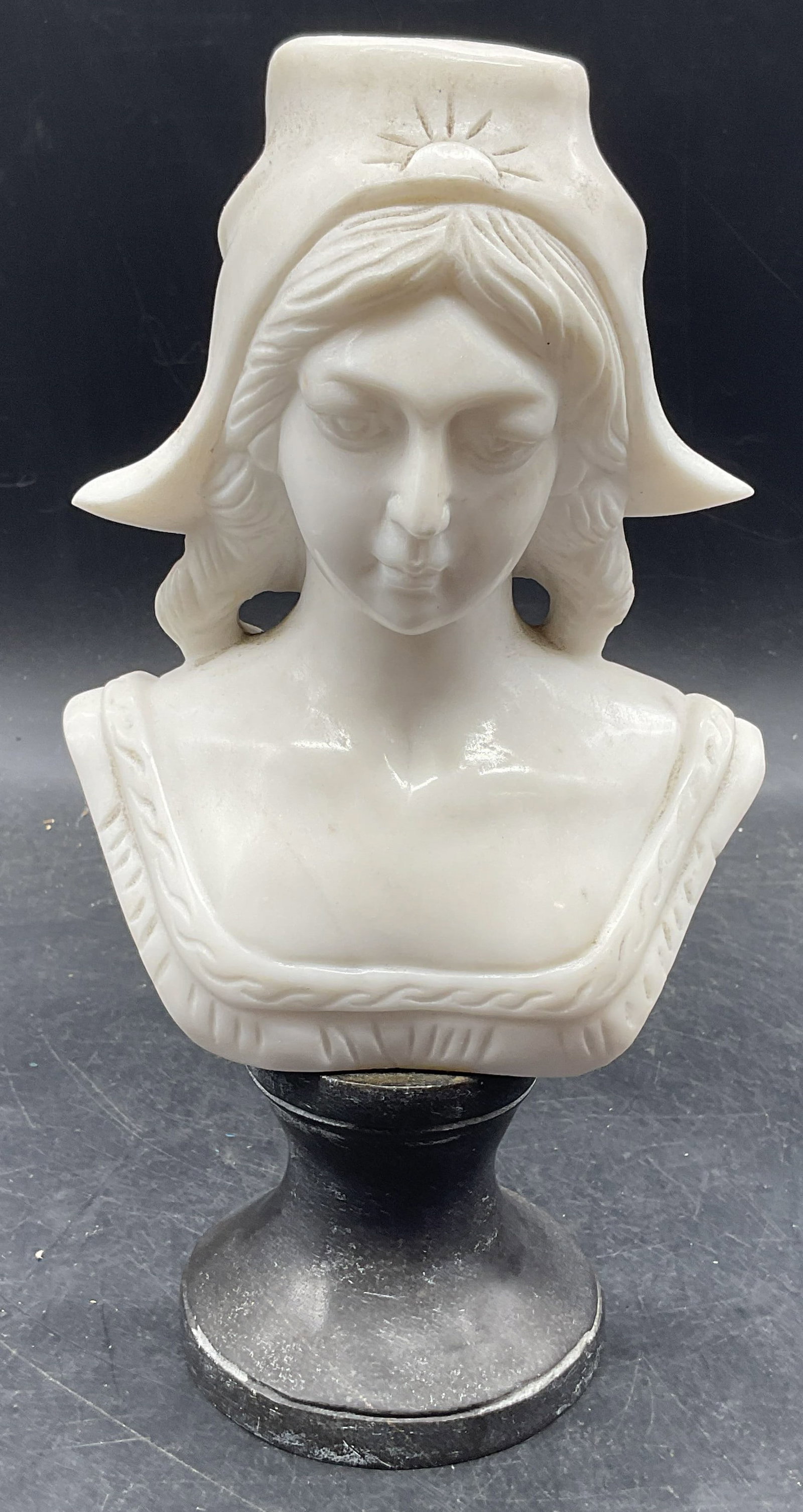 Antique Carved Marble Bust Of A Young Woman: Antique hand carved white marble bust of a young woman on black marble base. Measures approx. 5.5 x 3.5 x 10 inches. Some scratching and hairline. Piece has significant weight. Marble bust, bust of a