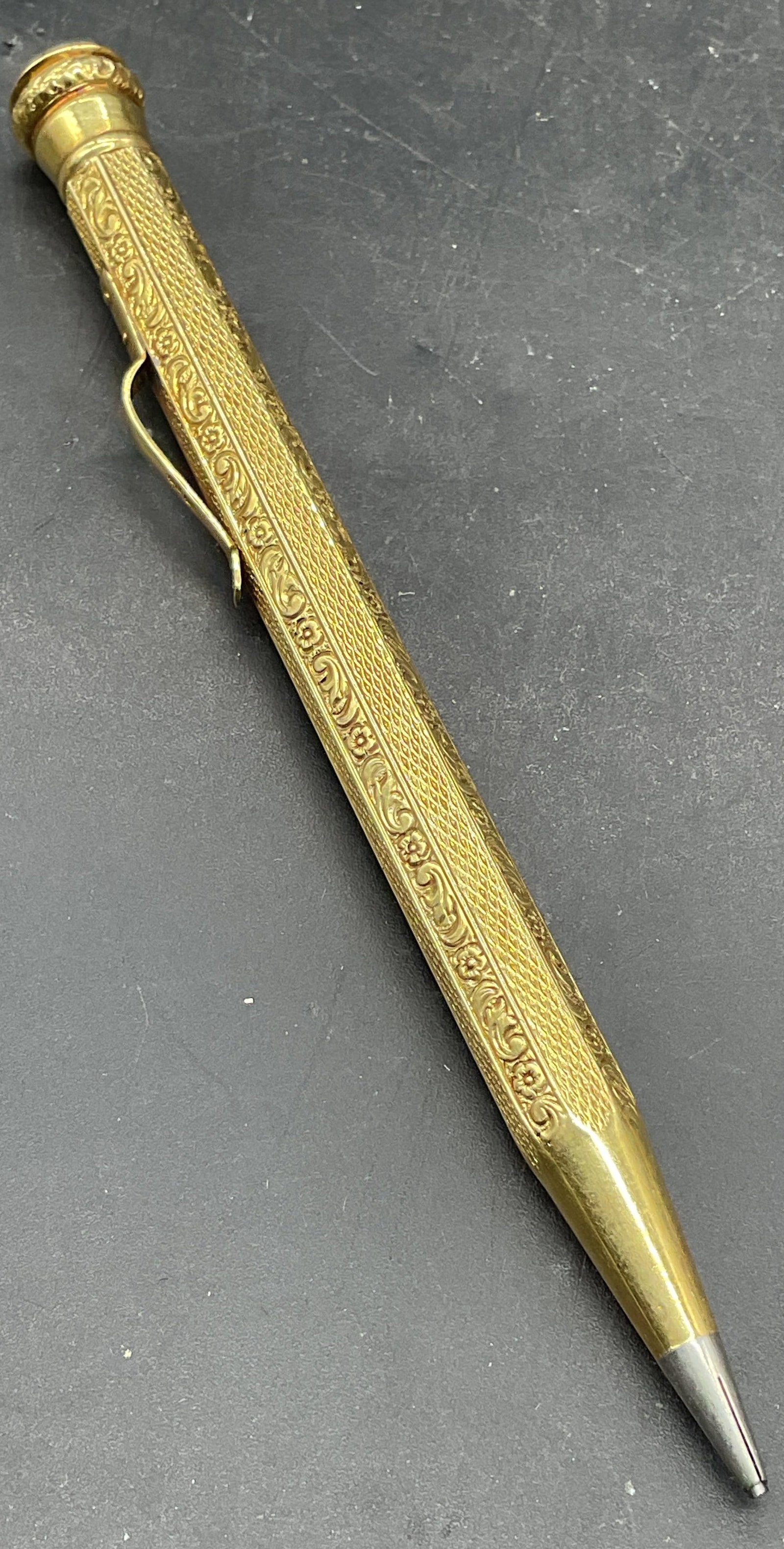 Vintage Signed 14K Gold Mechanical Pencil: Vintage 14k yellow gold mechanical pencil. Ornate chased floral scroll design on the case. Marked 585 on the clip, additional marks illegible. Measures approx. 4.5 inches long. Total weight including