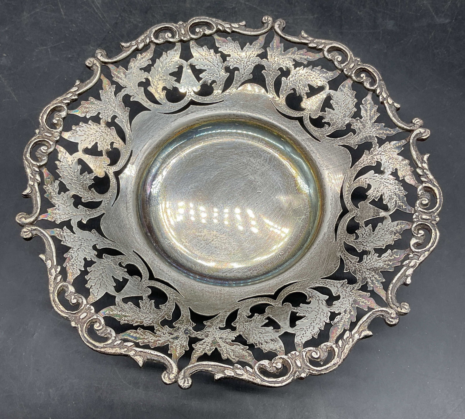 900 Silver Reticulated Footed Bowl, Egypt: 900 silver bowl with ornate reticulated foliate rim and scroll footed base. Egyptian silver hallmarks on underside. Marked 900 silver. Measures approx. 7 x 1.75 inches. Total weight 211.5 grams. Wear