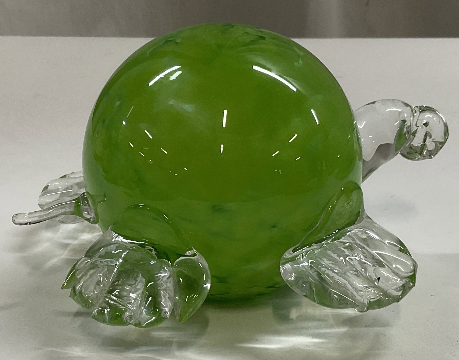 SGND Hand-Blown Green Glass Turtle Figurine: Signed Hand-Blown Glass Turtle Figurine. Round Swirled Green Glass Body with Clear Glass Head, Tail, and Feet. Signature Reads Illegibly. Some Chips. Measures app 4in H x 7in L. Signed Art Glass,