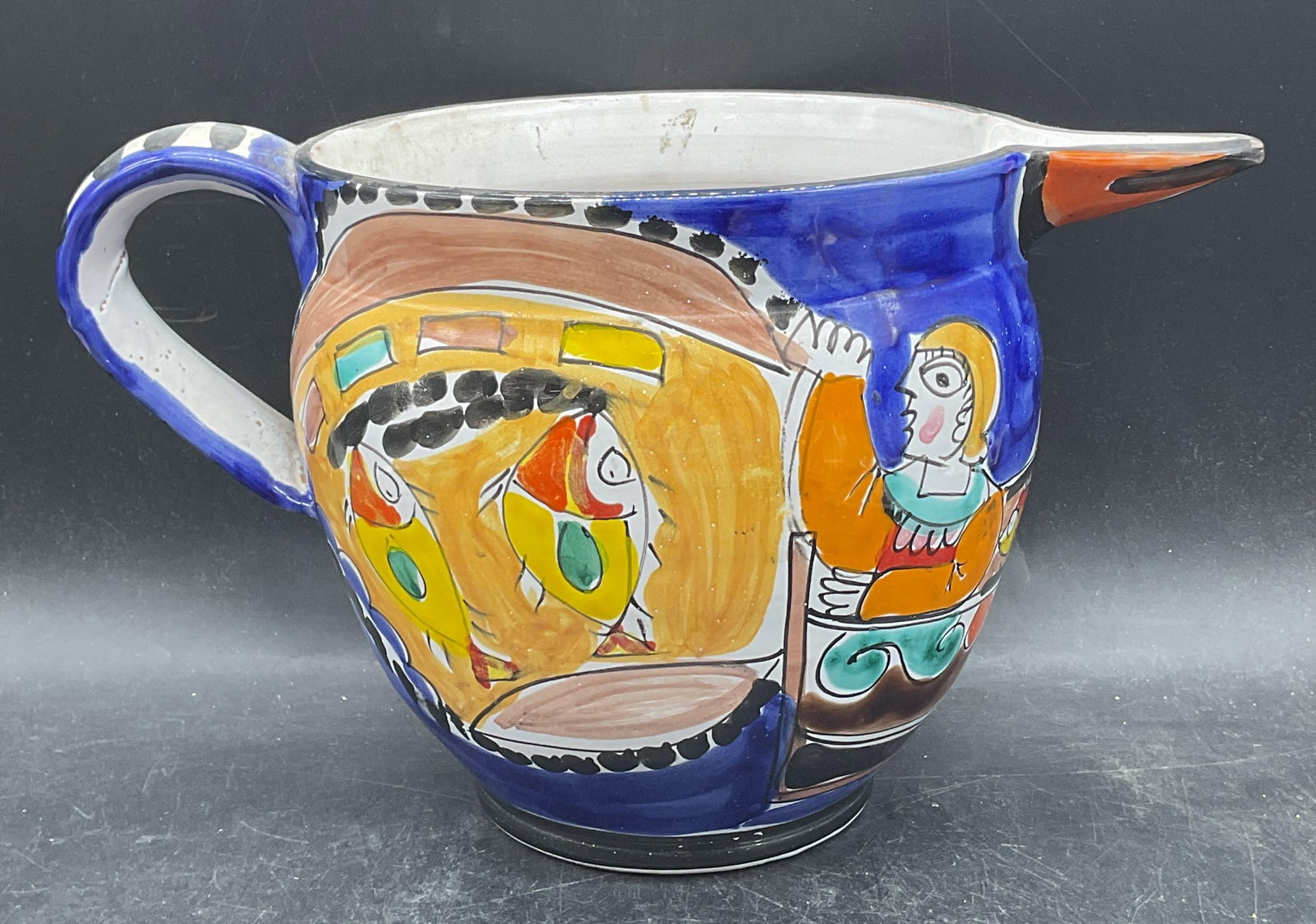 Vtg Saks Fifth Ave Italian Pottery Fish Pitcher: Vintage Italian pottery pitcher. Handmade and hand painted polychrome fish and figure motif. Made in Italy for Saks Fifth Avenue. Measures approx. 12.25 x 7.5 x 7.25 inches. Some scratching and