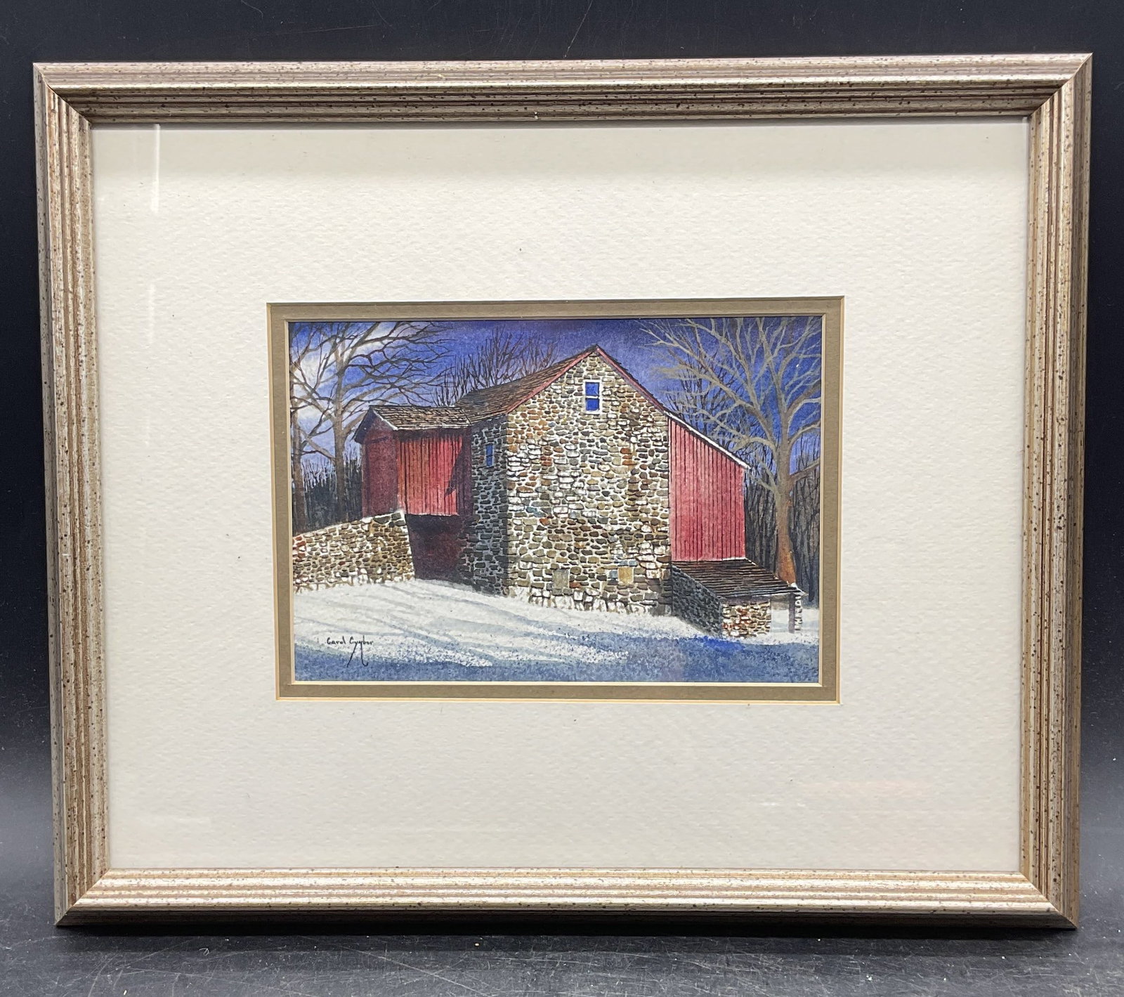Sgn Carol Cymbor Winter Barn Watercolor Painting: Framed and matted watercolor painting. Signed lower left, Carol Cymbor (American, 20th century). Late Afternoon. Winter landscape with view a barn. Silver tone wood frame. Not examined out frame.