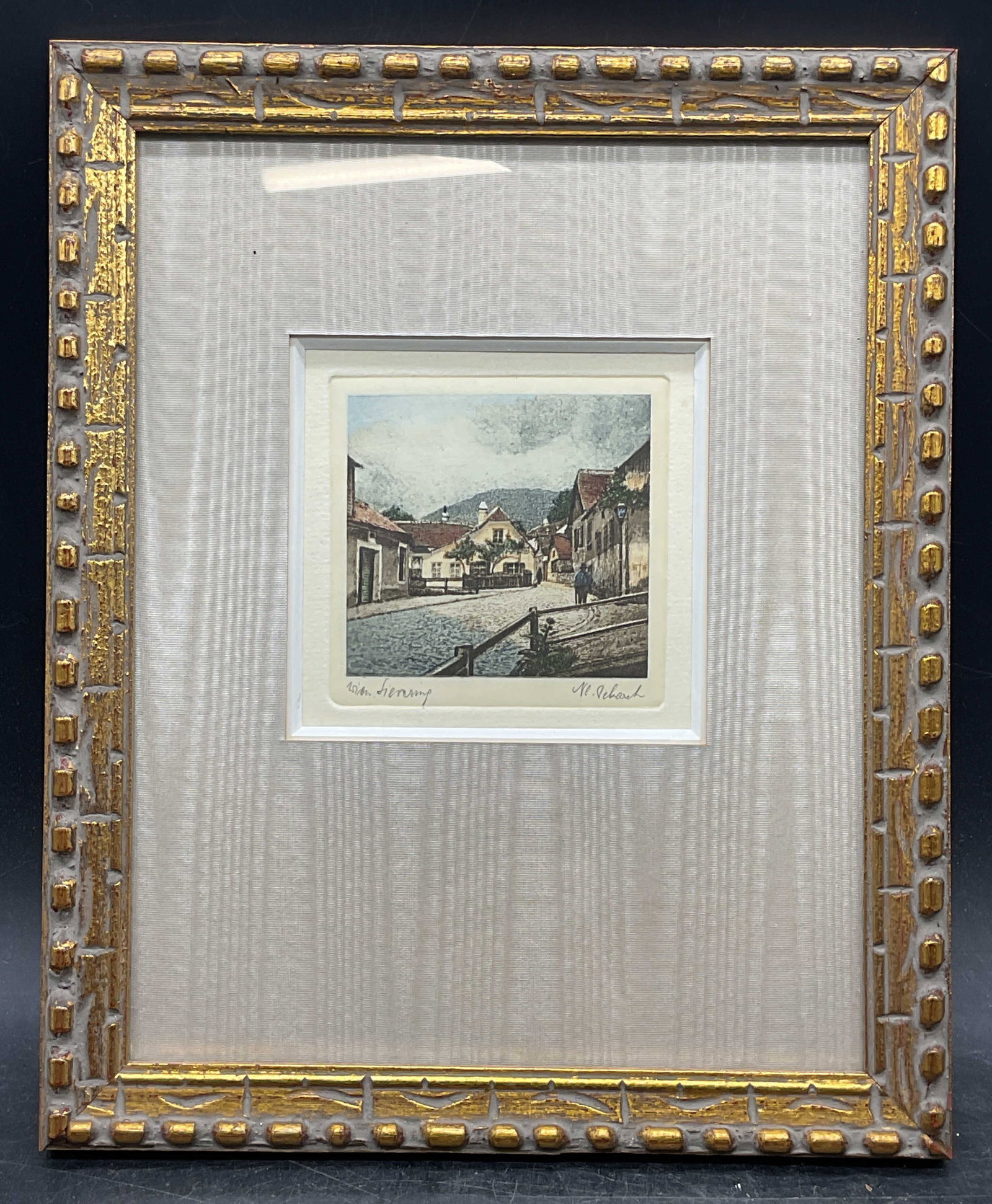 Signed N. L. Pekarek European Scene Etching: Framed and matted colored etching on paper. Signed lower right, N. L. Pekarek (Austrian, 20th century). Inscribed lower left, illegible. European city scene with view of street and buildings.