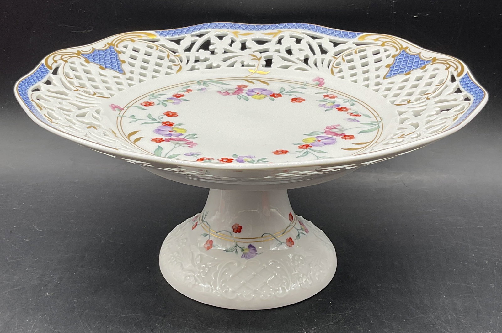 Oscar De La Renta Angelique Porc Cake Stand German: Vintage Oscar de la Renta porcelain cake stand. Angelique pattern. Reticulated rim with hand painted and gilt floral designs. Made in West Germany. Measures approx. 10.5 x 5 inches. Some scratching. O