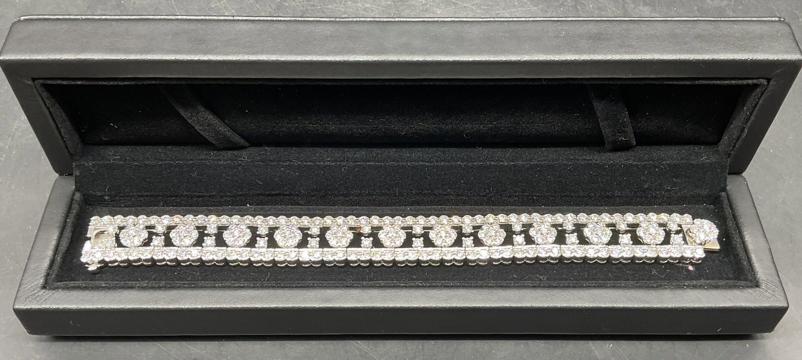 Platinum & Diamond Floral Bracelet 19Ct: A platinum bracelet set with diamonds, floral motif band. Approximately 225 stones according to insurance schedule. 19 carats total according to insurance schedule. Measures approx 7.5 inches long. Ba