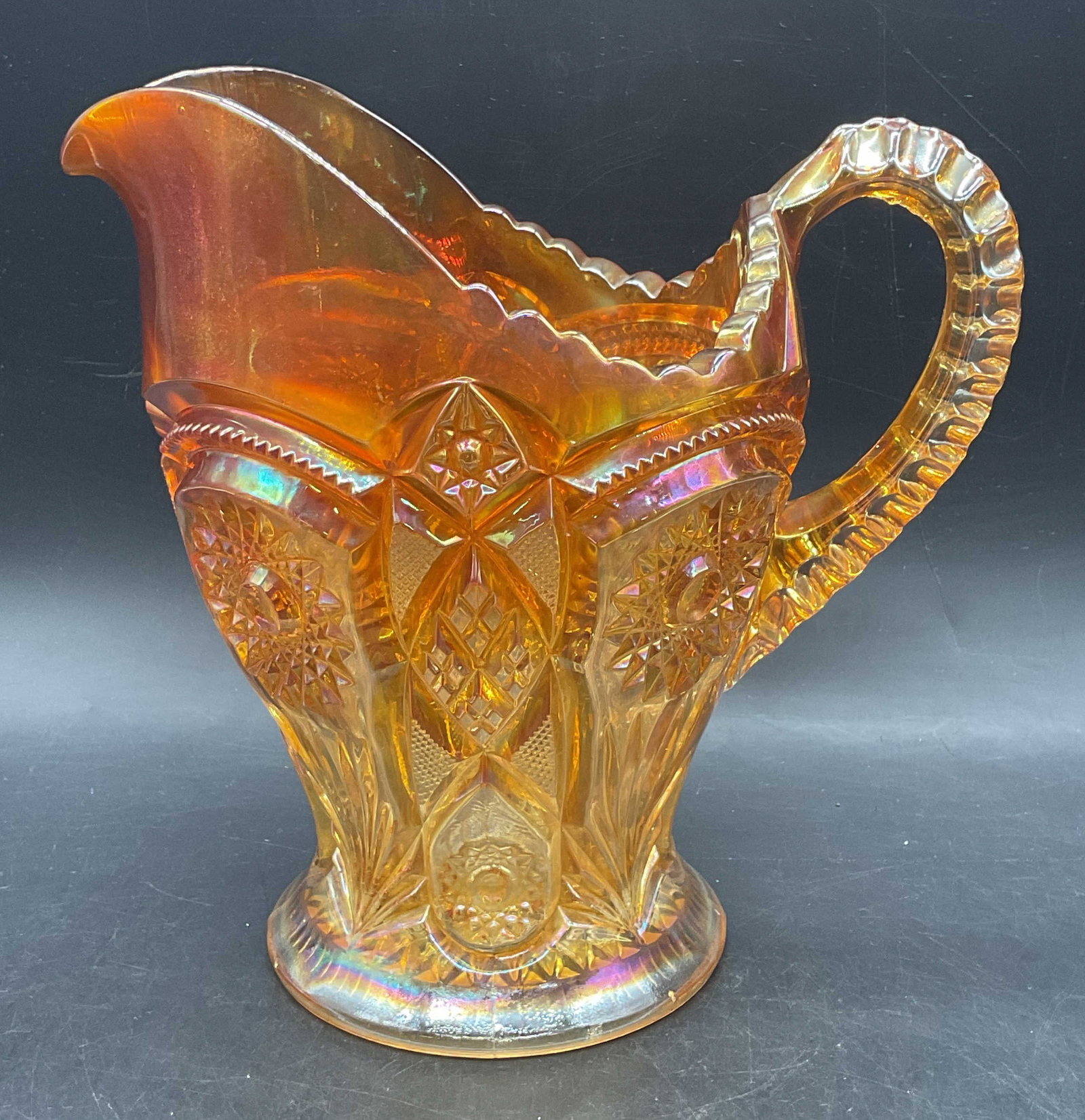 Imperial Glass Marigold Carnival Glass Pitcher: Vintage Imperial Glass carnival glass pitcher. Fashion Marigold pattern. Unmarked. Measures approx. 8.5 x 5.5 x 8.5 inches. Some scratching. Factory imperfection on rim. Imperial glass pitcher,