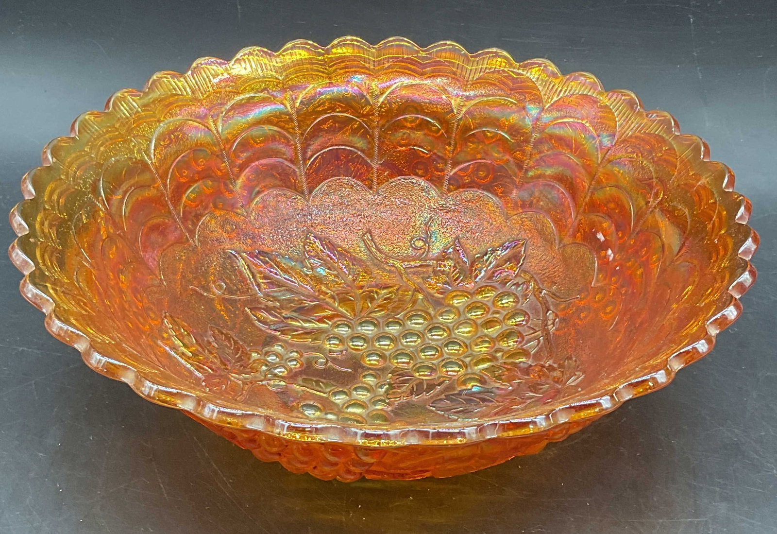 Imperial Marigold Carnival Glass Grape Bowl: Vintage Imperial Glass marigold carnival glass bowl. Grace with leaves pattern. Unmarked. Measures approx. 10 x 3.25 inches. Some scratching. Imperial glass bowl, marigold bowl, carnival glass bowl,