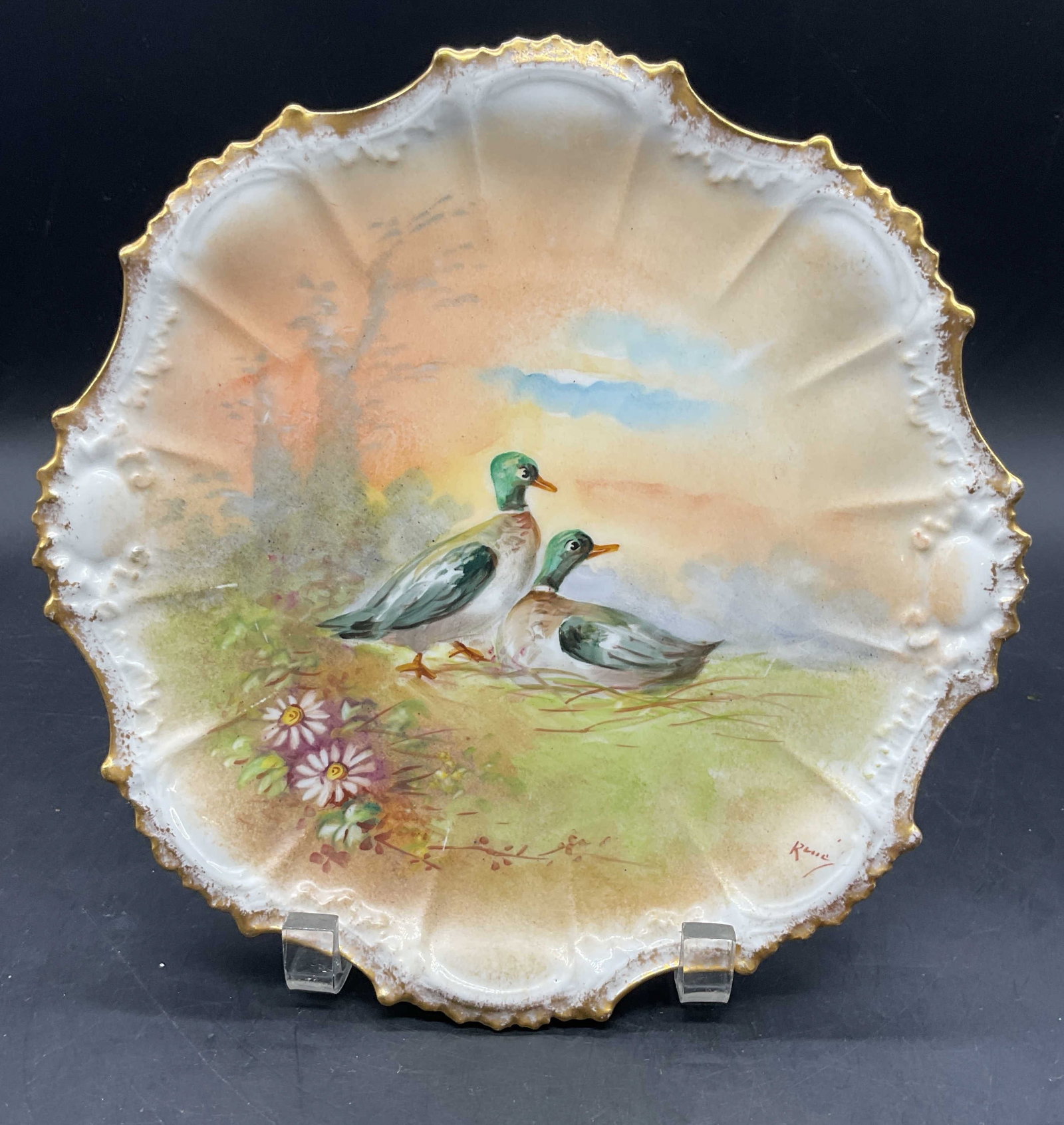 Antique LDBC Limoges Porc Duck Plate France: Antique LDBC Limoges porcelain plate, scalloped edge with hand painted and gilt duck motif. Signed on the plate illegibly. Backstamp on underside. Made in France. Measures approx. 9.5 inches wide.