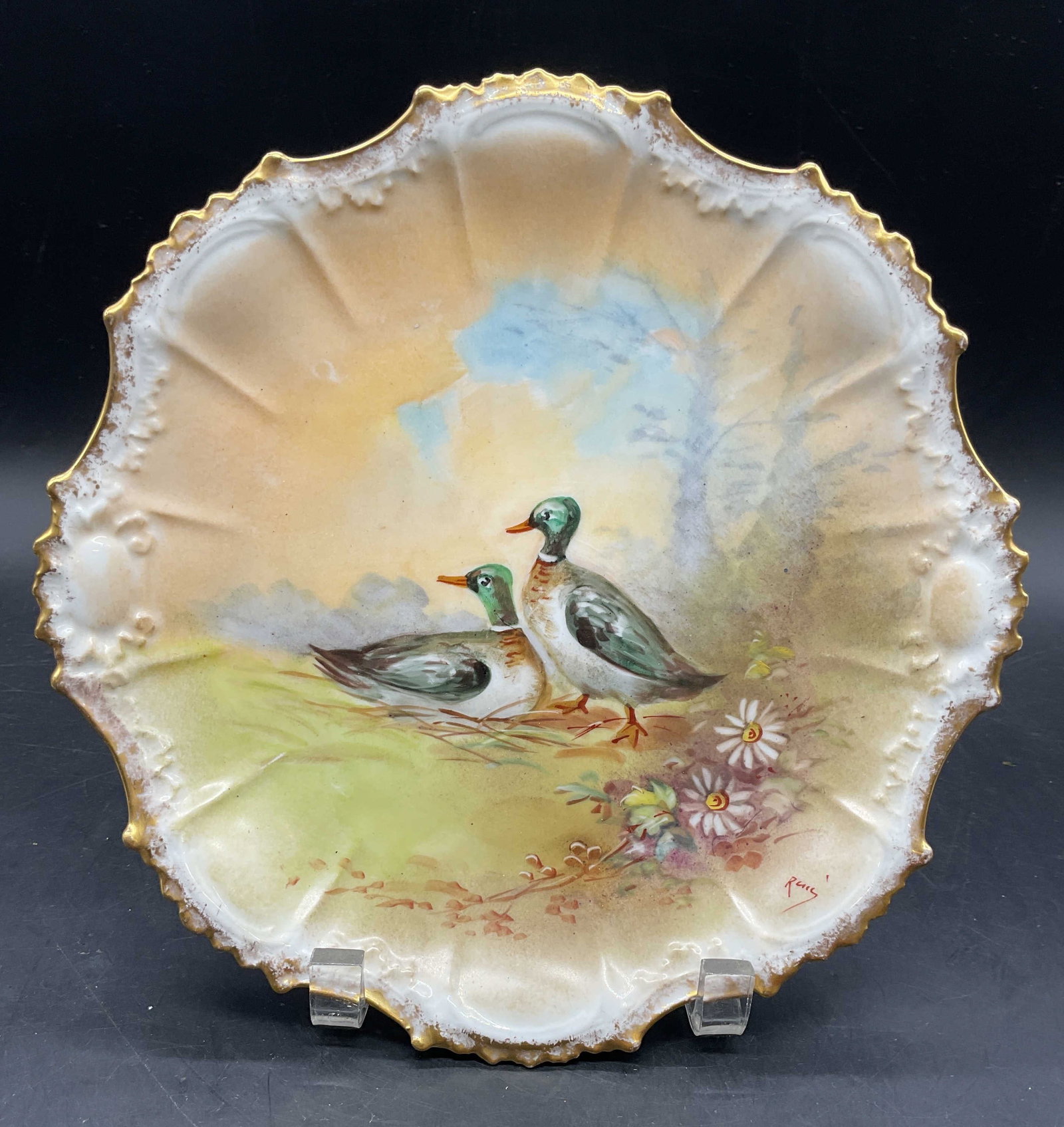 Antique LDBC Limoges Porc Duck Plate France: Antique LDBC Limoges porcelain plate, scalloped edge with hand painted and gilt duck motif. Signed on the plate illegibly. Backstamp on underside. Made in France. Measures approx. 9.5 inches wide.