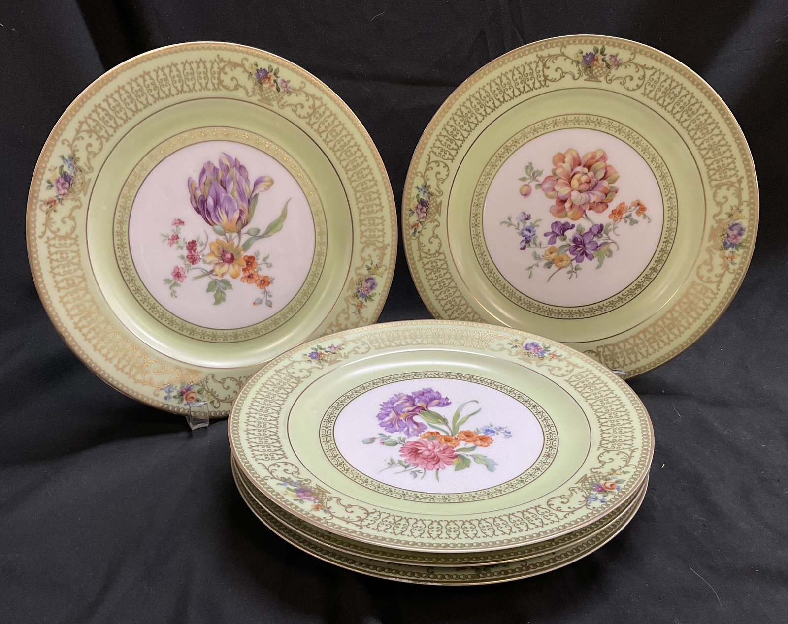 St5 ANTQ Tirschenreuth Bavaria Porc Floral Plates: Set of 5 Antique Tirschenreuth Bavaria Porcelain Plates. Light Celery Green Rim with Etched Gilt Scroll Design. Hand-Painted Florals in Center. Some Fading. Measures app 1in H x 10.75in Diam. Antique