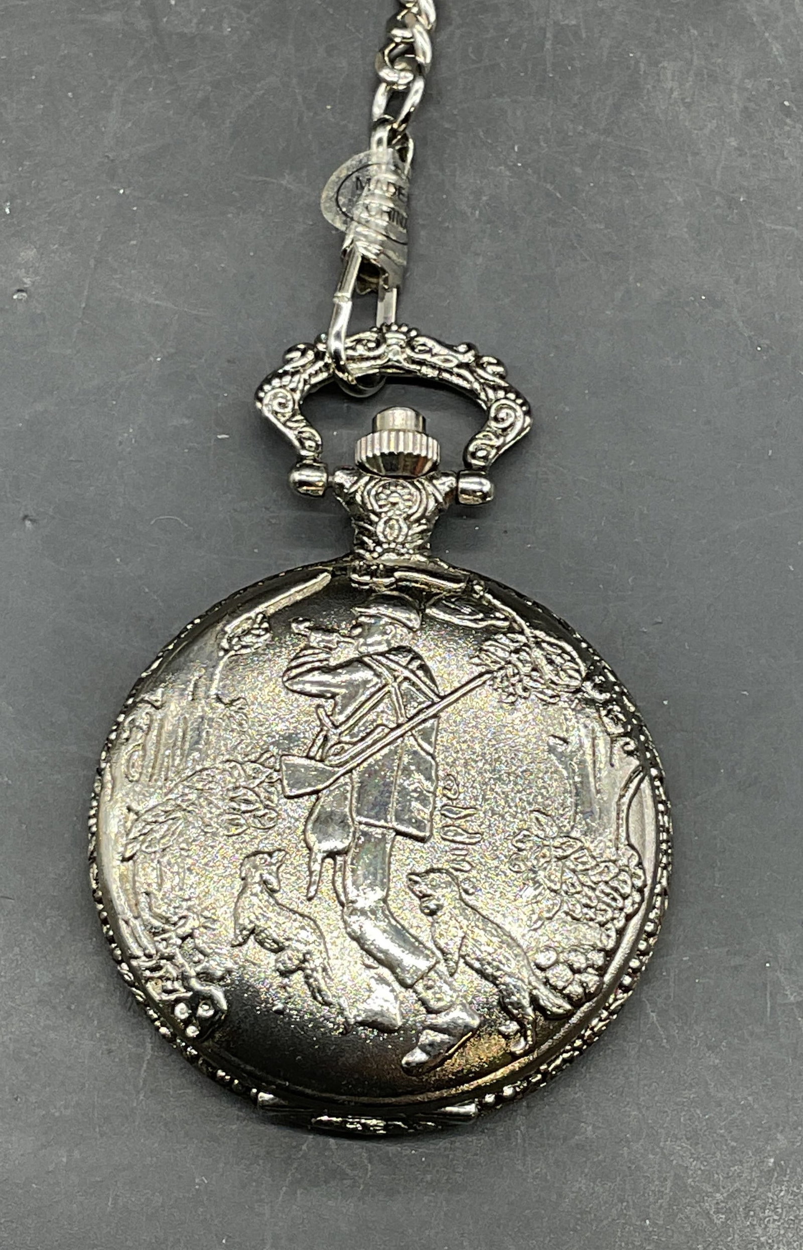 Paul Jardin Silver Tone Hunt Scene Pocket Watch: Vintage Paul Jardin silver tone pocket watch with embossed hunt scene on cover. Includes chain. Measures approx. 1.75 inches wide. Chain measures approx. 14.5 inches long. Includes a box. Not tested.