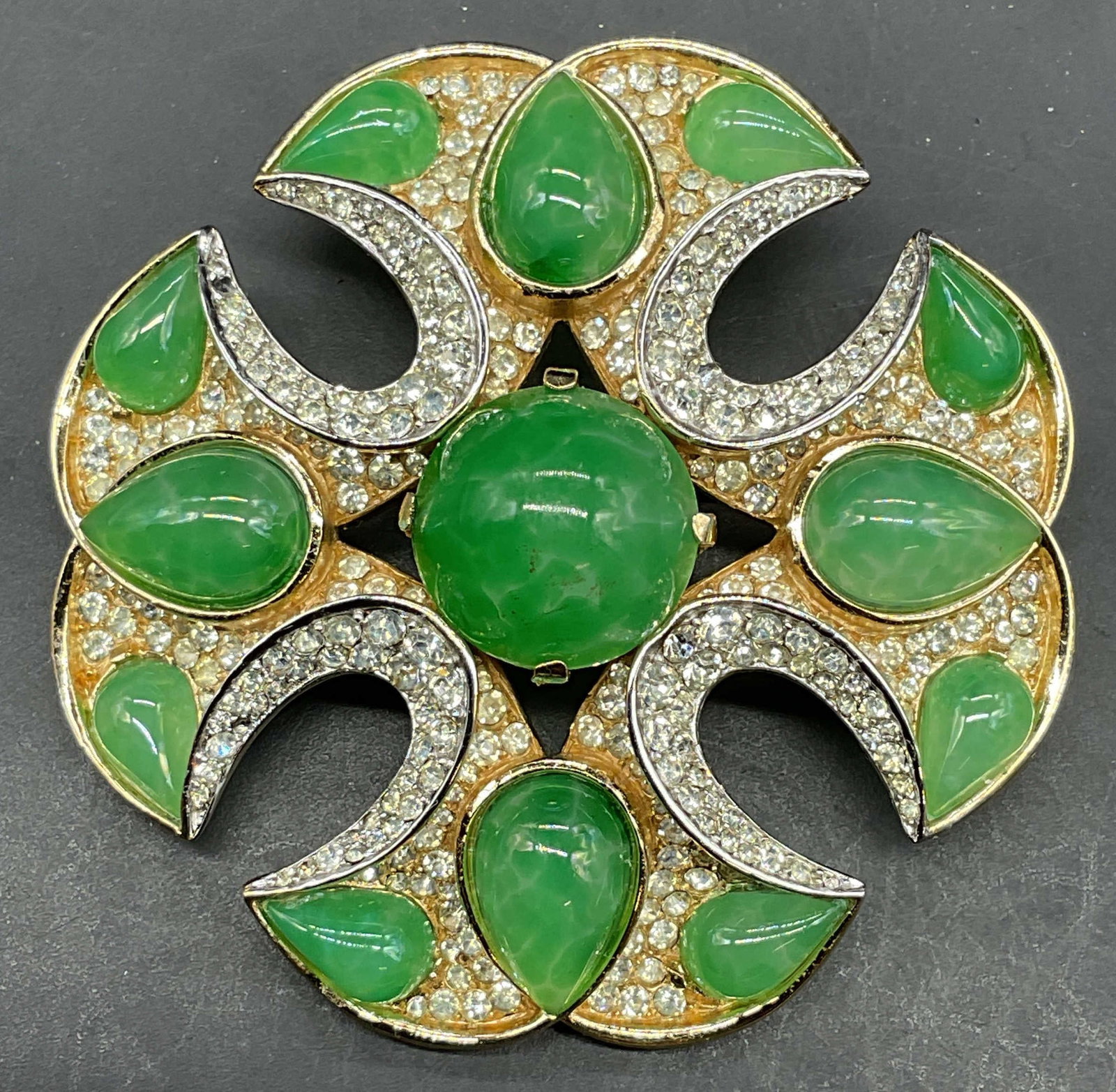 1960s Trifari Maltese Cross Jewels of India Brooch: Vintage circa 1960 Trifari Jewels of India collection Maltese cross brooch. Gold tone with pave crystals and green lucite cabochons. Measures approx. 2.25 inches wide. Some scratching. Jewelry,